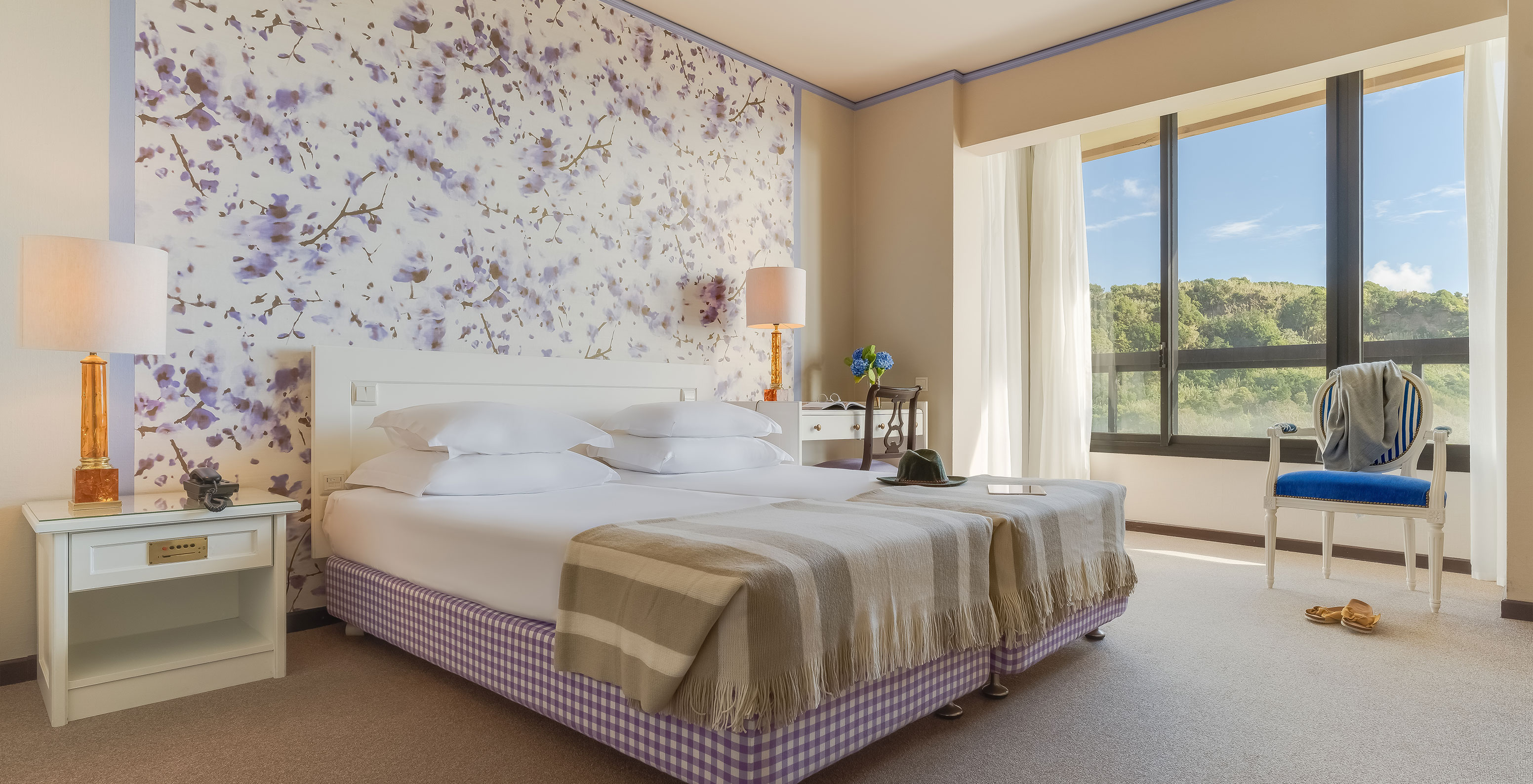 Standard Garden View room at Pestana Bahia Praia is a spacious room with two beds, a bedside table and a desk