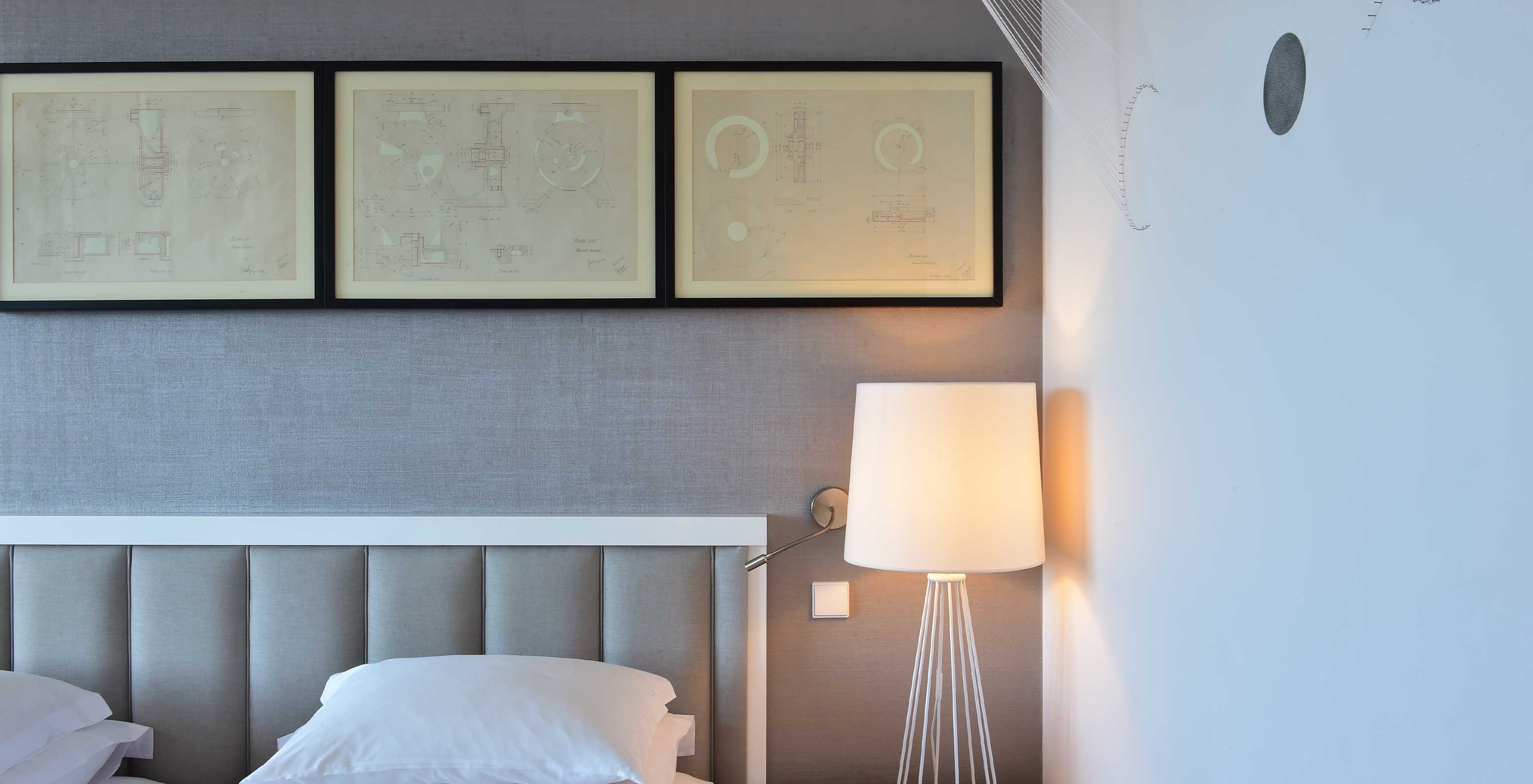 The Double Room Art District at Pestana Cidadela Cascais features an art wall, bedside table with a lamp, and paintings