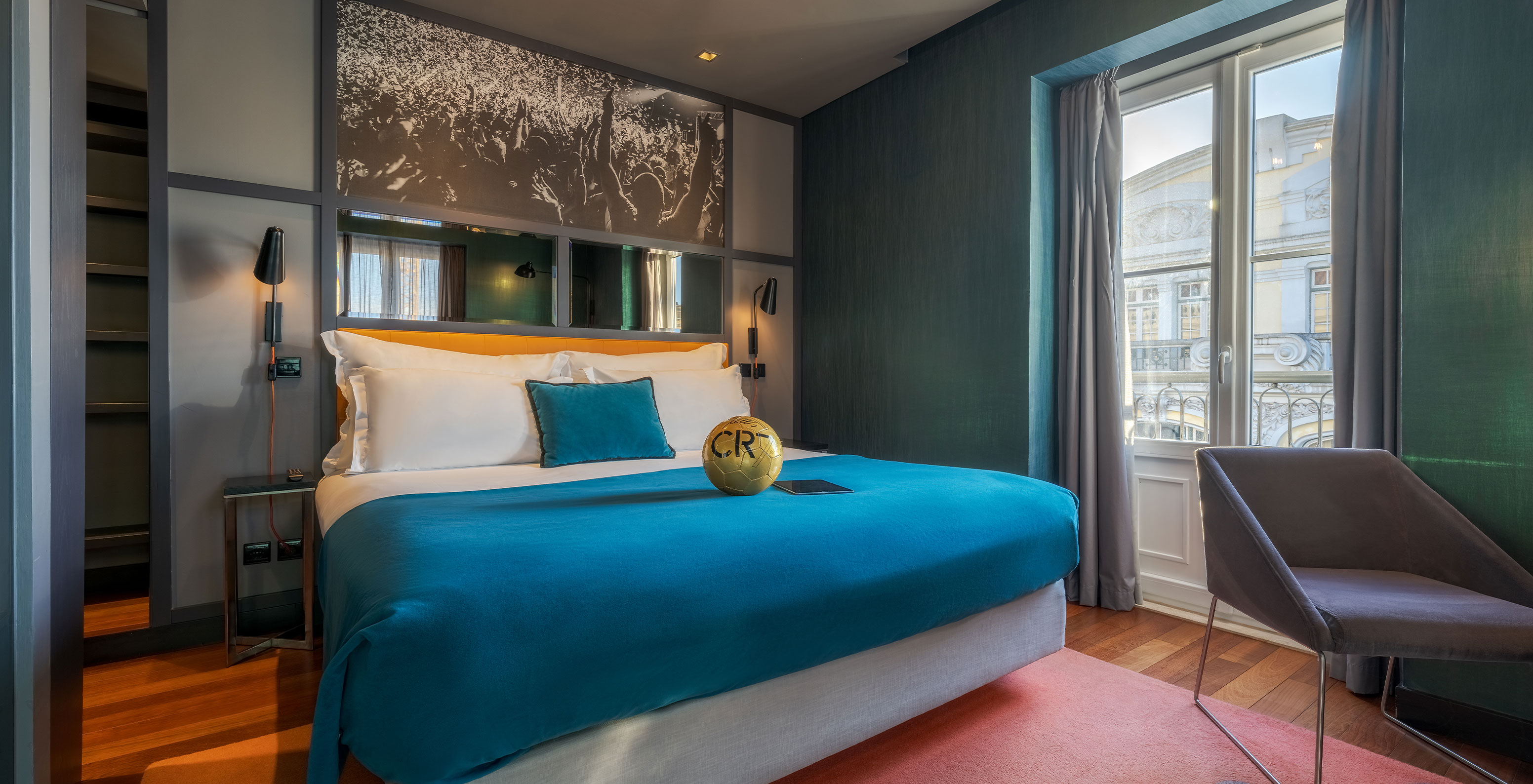 The CR7 Superior Room at Pestana CR7 Lisboa has a double bed and a Cristiano Ronaldo football