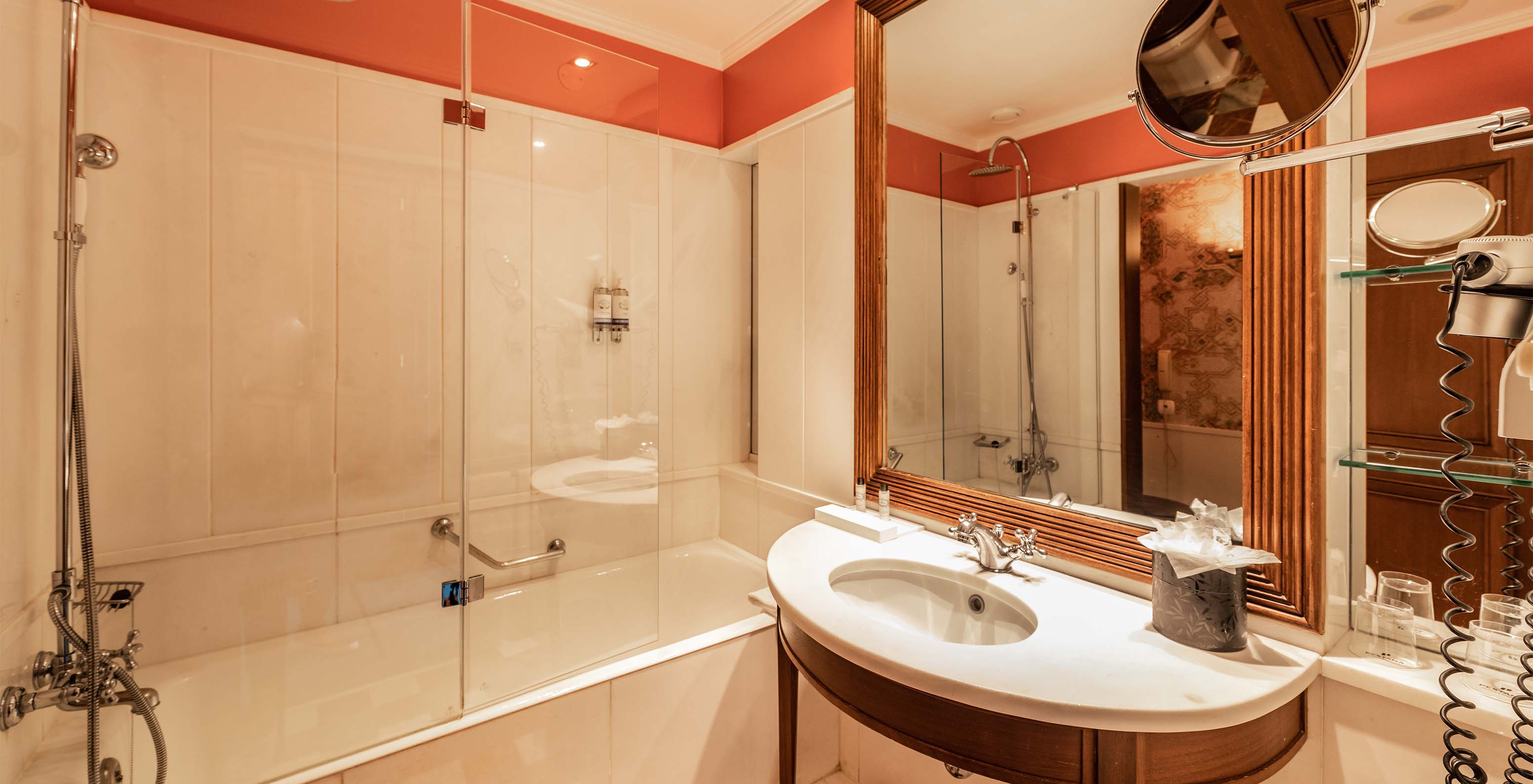 The Premium Balcony room at Pestana Palace Lisbon features a bathroom with a bathtub and sink with a mirror