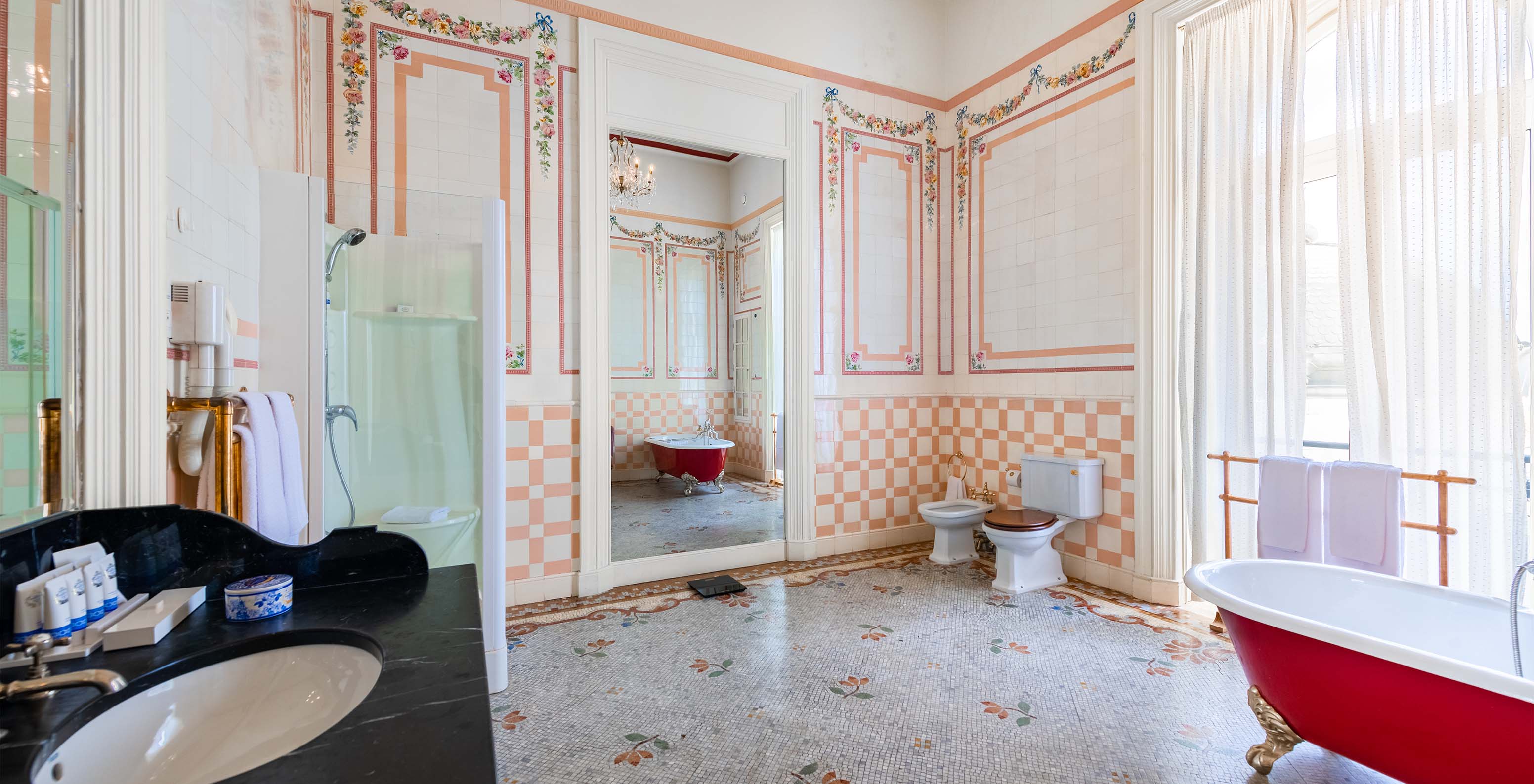 The Suite D. Amélia at Pestana Palace Lisbon features a spacious bathroom with tiles, a window, a bathtub, shower, and mirror