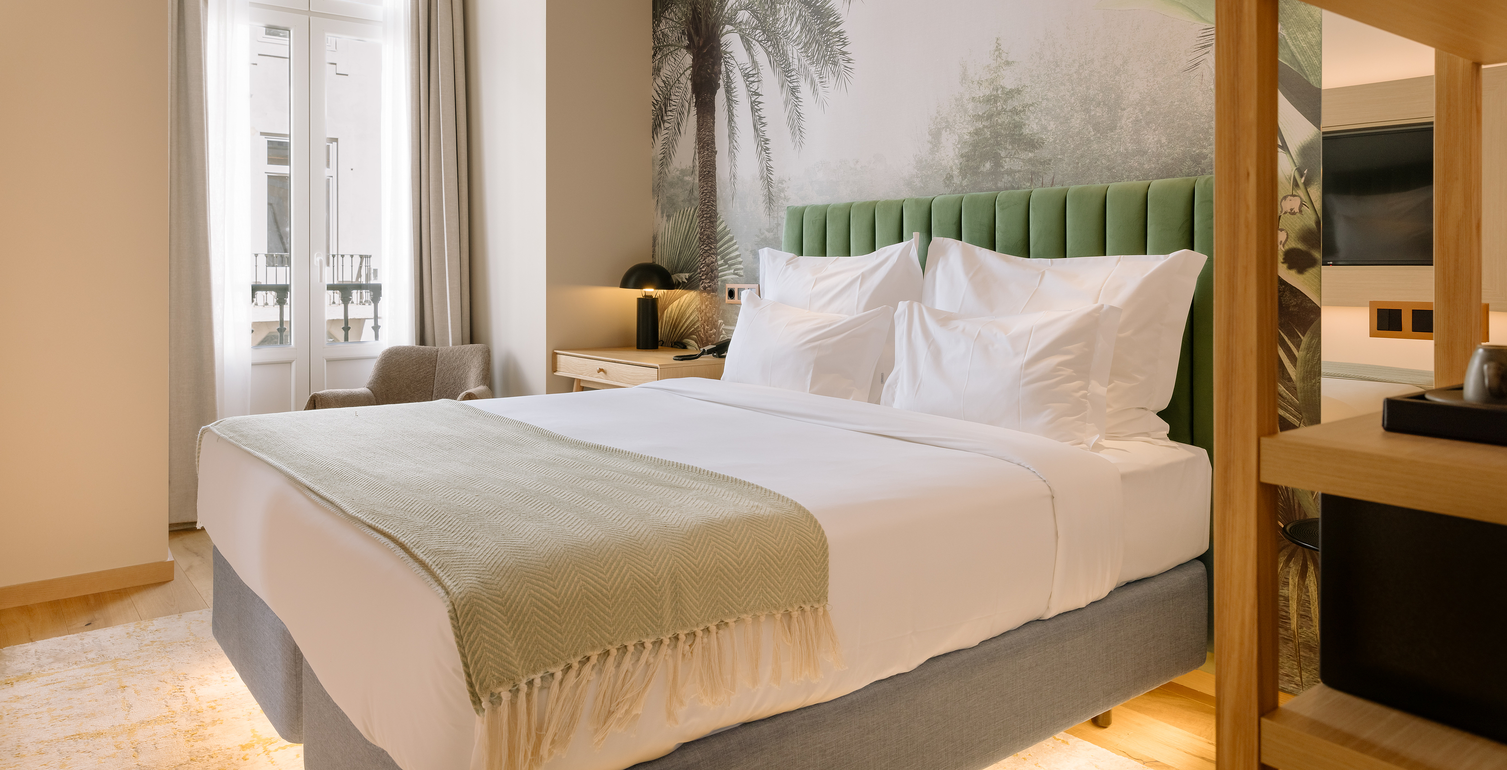 The Classic Room of Pestana Rua Augusta Lisboa has a double bed and window with curtains and view of downtown Lisbon