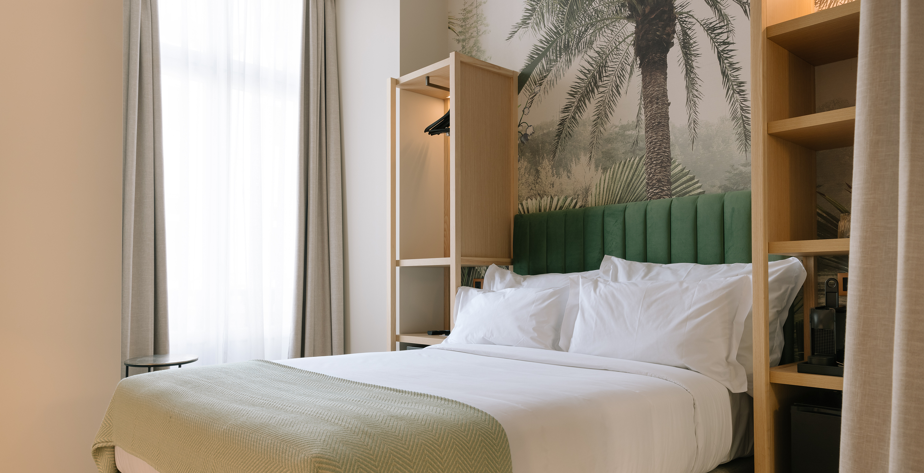 The Cozy of Pestana Rua Augusta Lisboa has a double bed with green suede headboard and two small wardrobes on each side