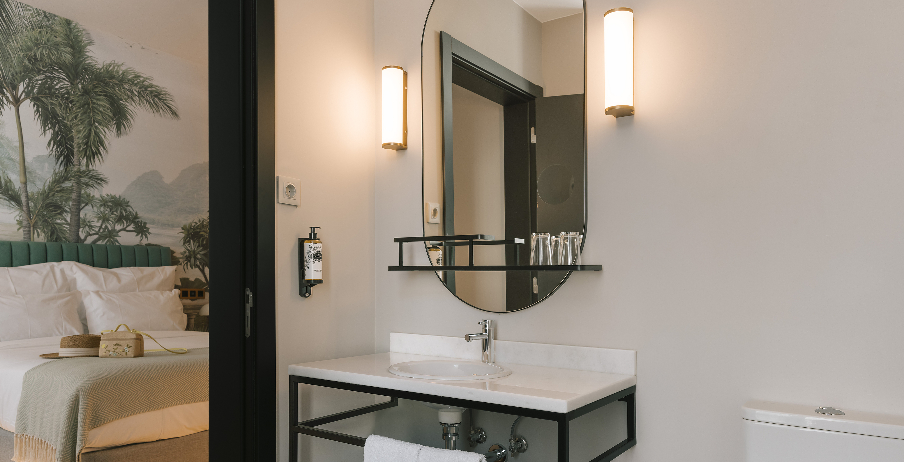 The Superior Room of Pestana Rua Augusta Lisboa has a bathroom with white marble sink, mirror, and towels