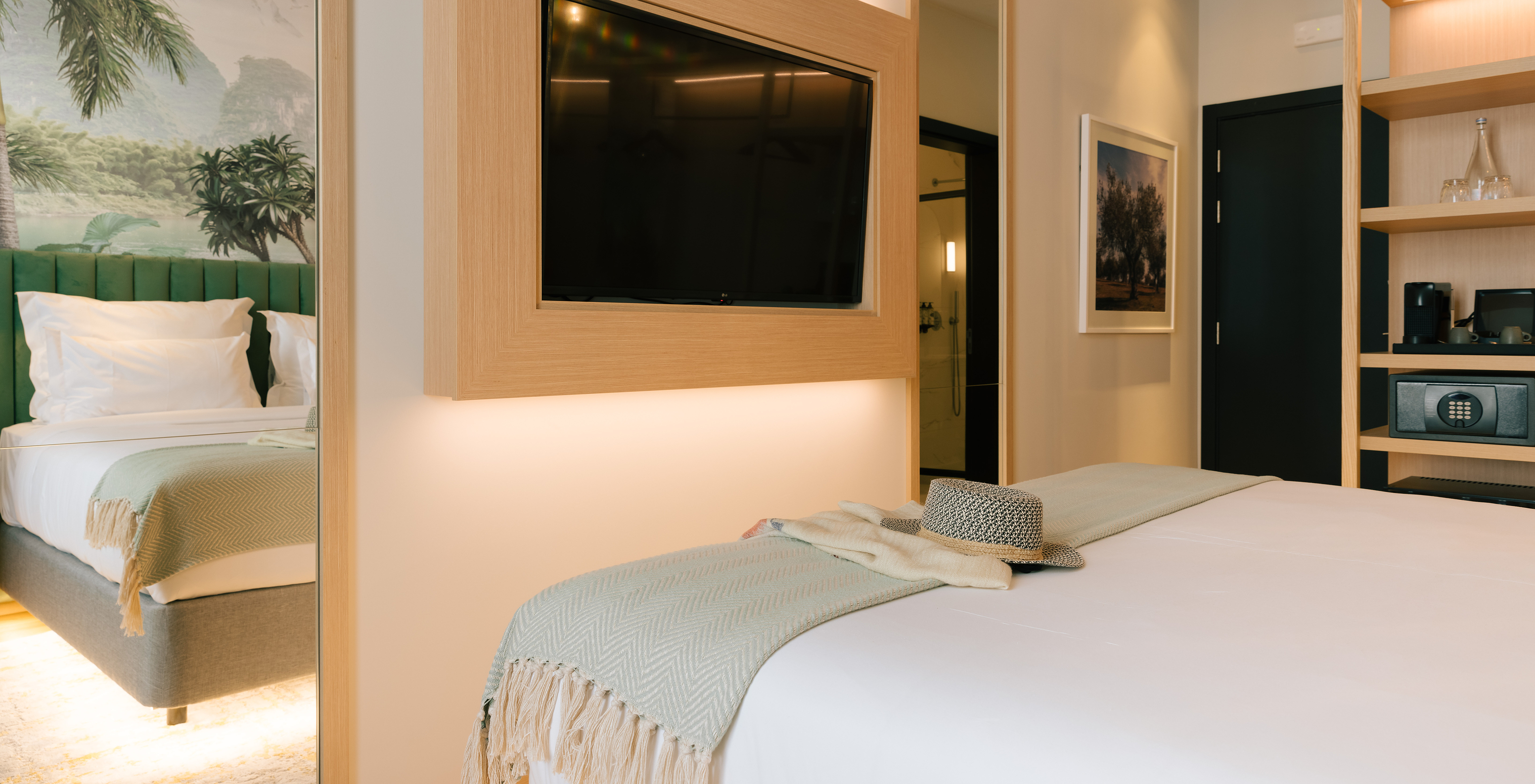 The Classic Room of Pestana Rua Augusta Lisboa has a television in front of the bed and a wardrobe with shelves and a safe