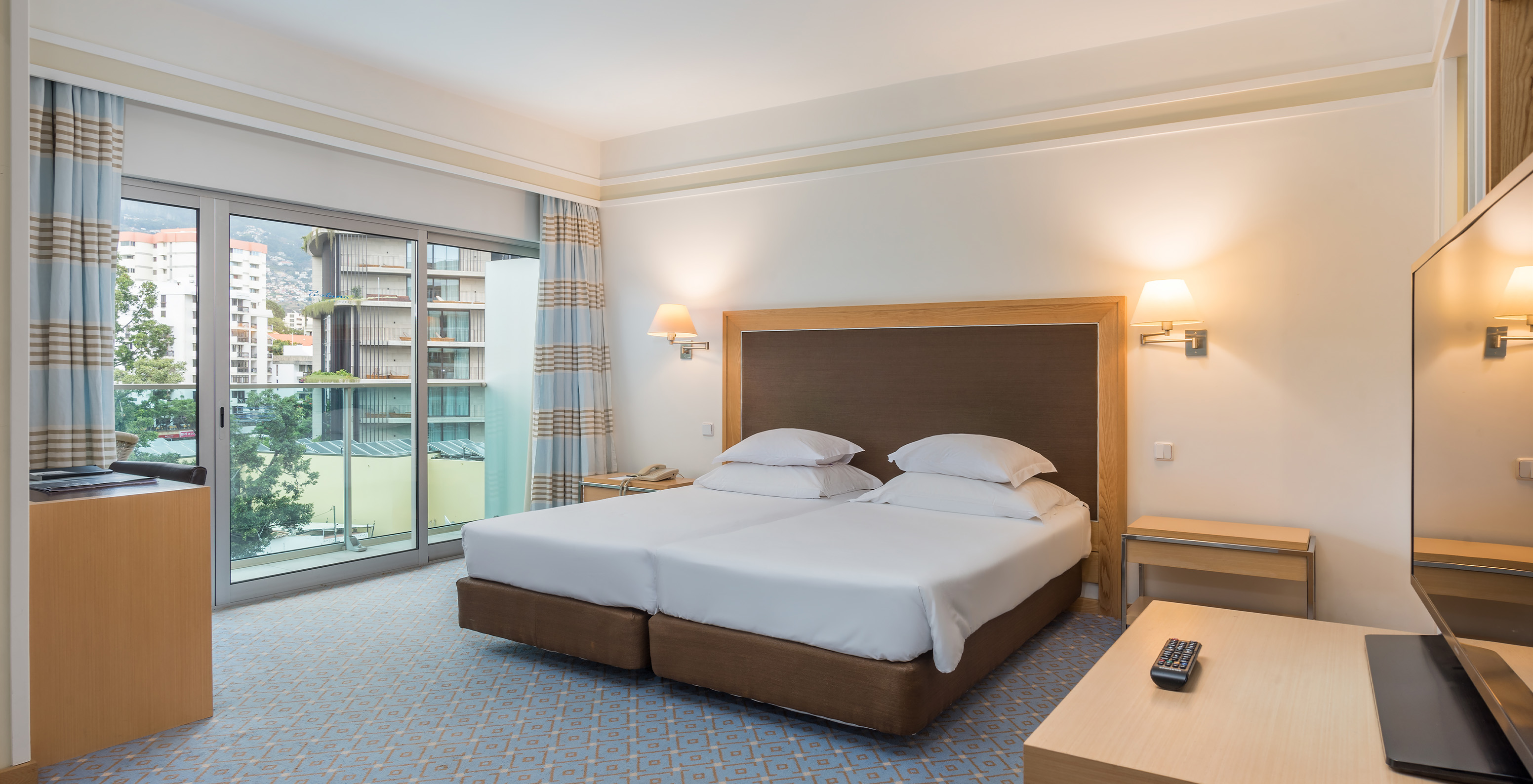 The Family Double Room at Pestana Carlton Madeira has a spacious area, a double bed, and a balcony