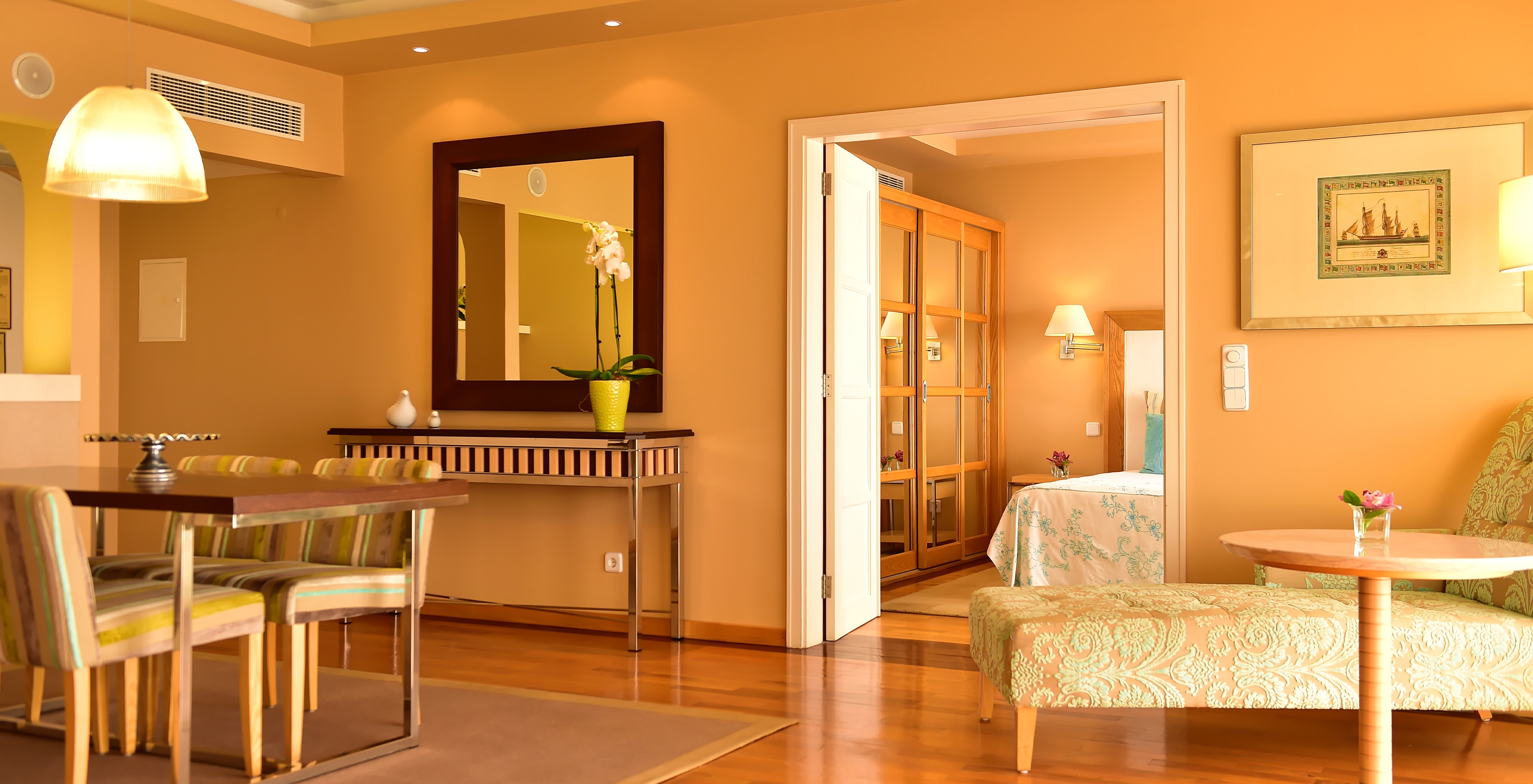 The Presidential Suite at Pestana Carlton Madeira has a spacious area with dining and living zones, and a double bed