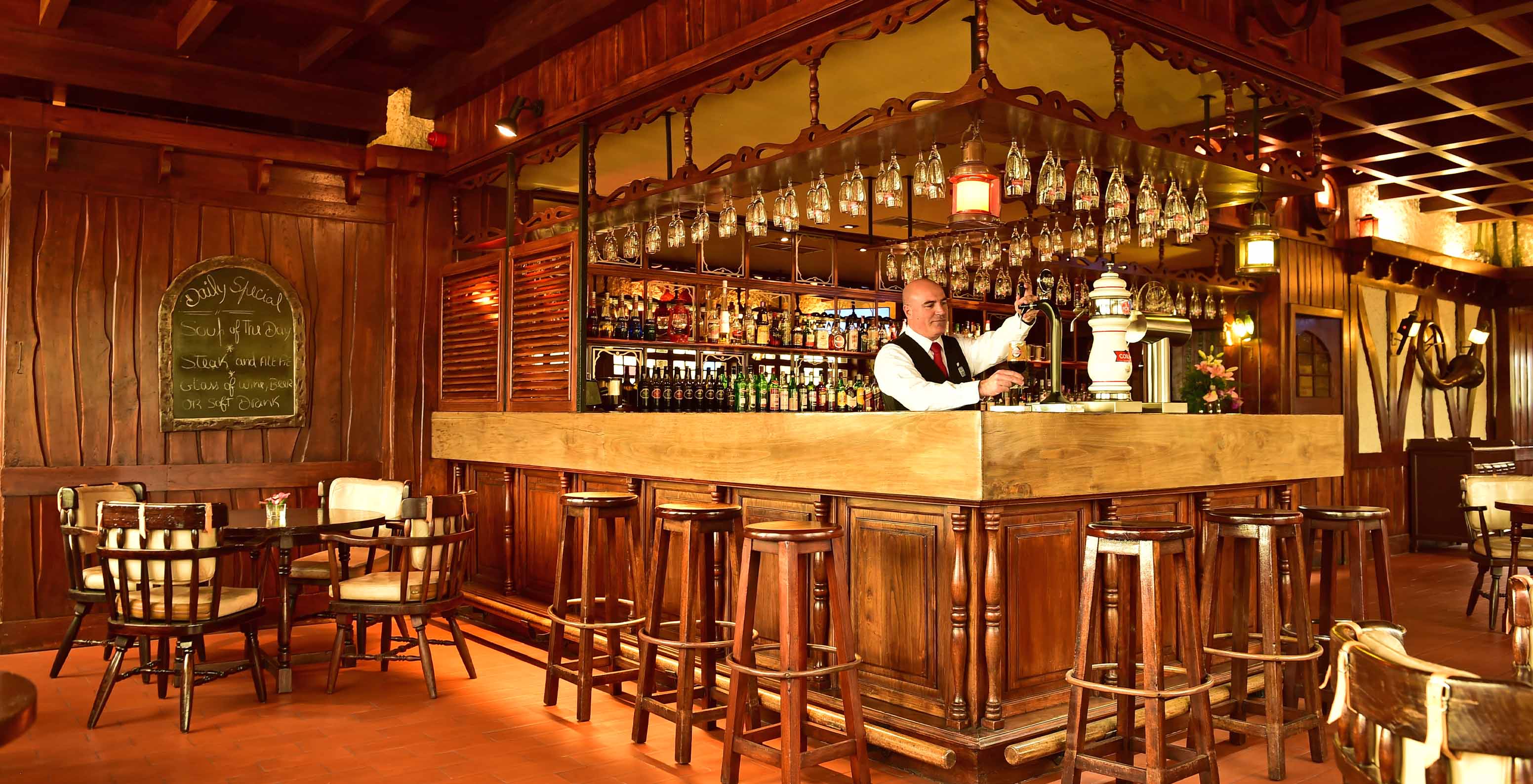 The Pub bar in Madeira has a counter surrounded by high stools and various drinks