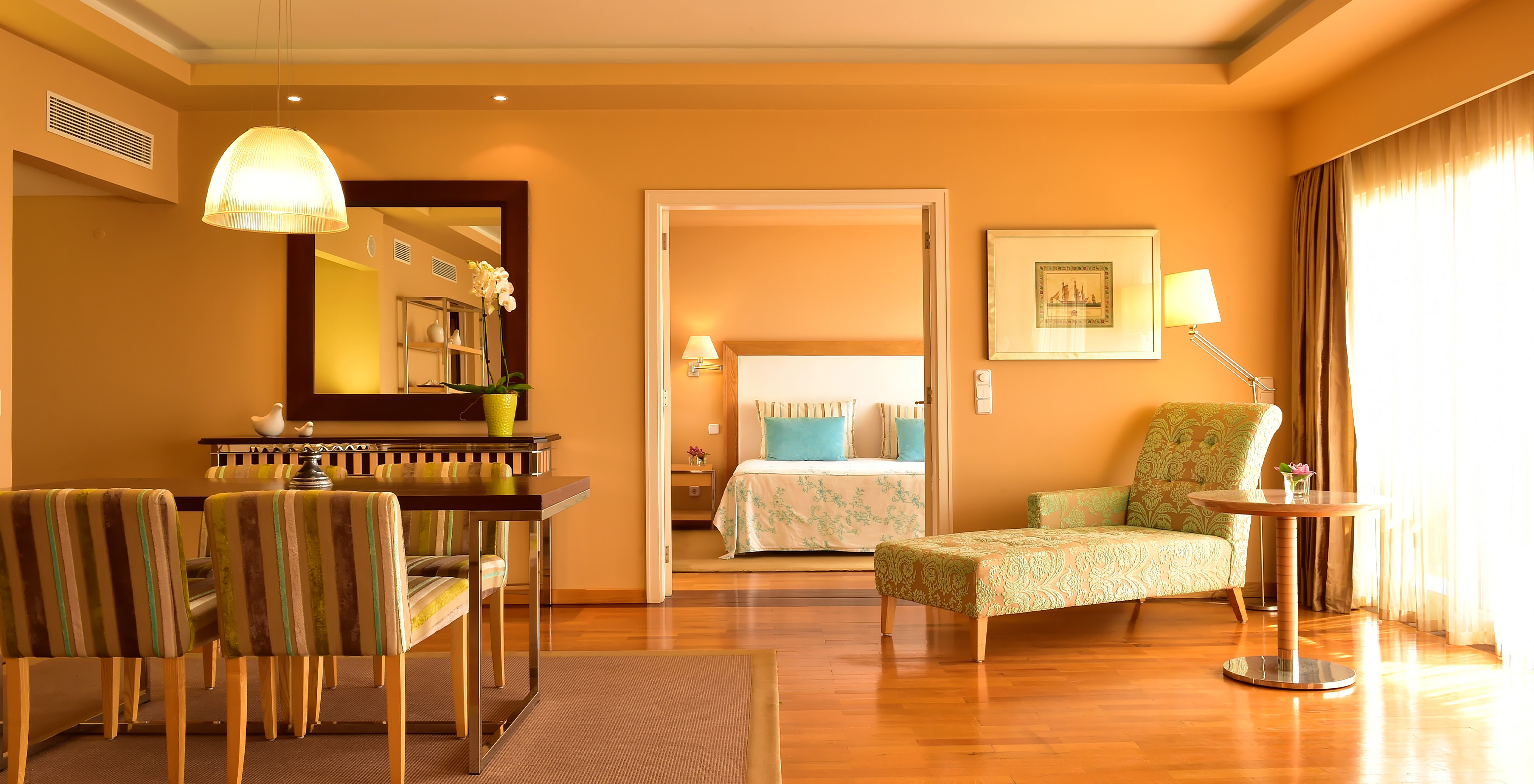 The Presidential Suite at Pestana Carlton Madeira has a spacious area with dining, a chaise longue, and a double bed