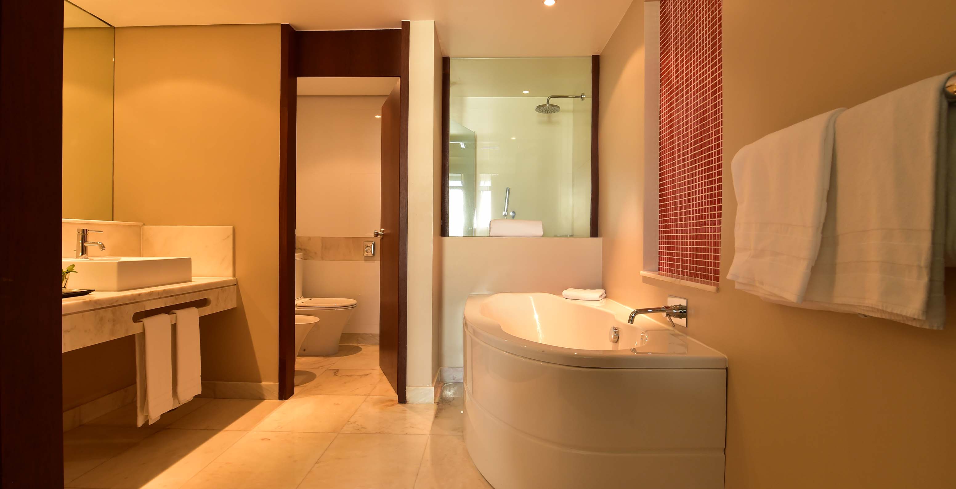 The Family Room at Pestana Casino Park has a bathroom with a bathtub and shower, toilet, and sink