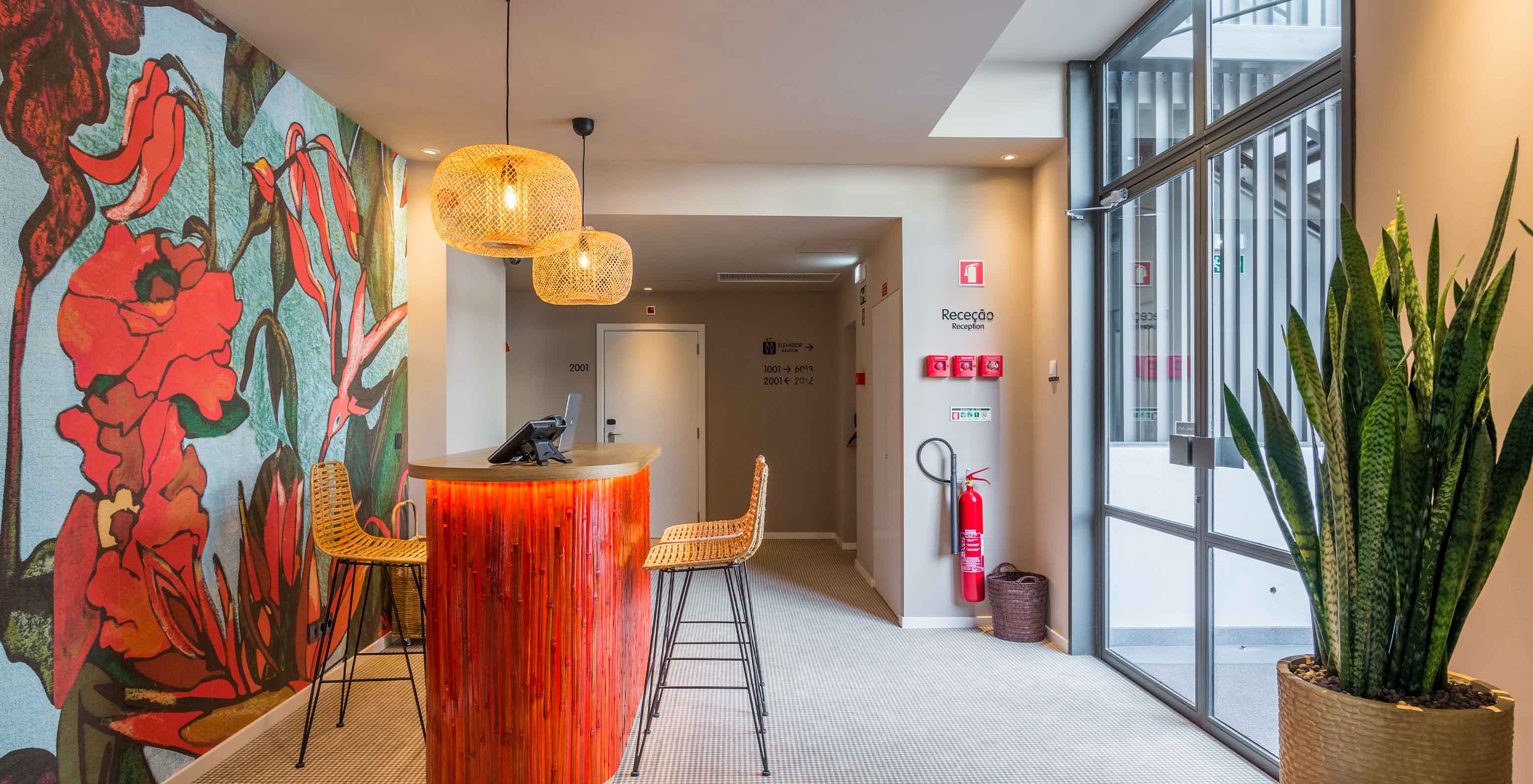 Pestana Casino Studios, with Apartments in the City Center, has an entrance with a red desk