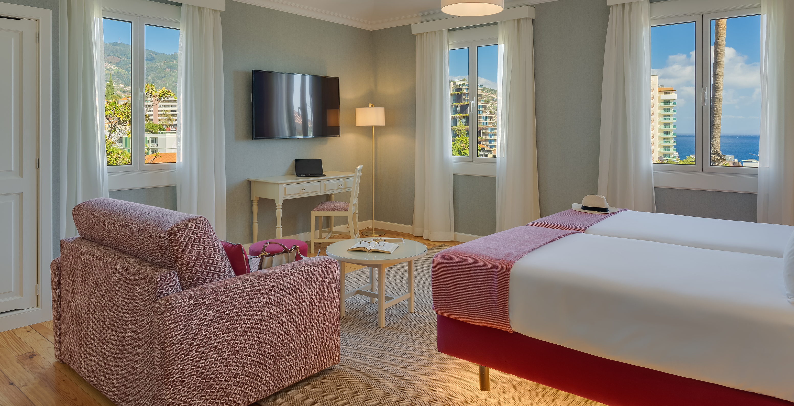 Partial Sea View Junior Suite at Pestana Quinta Perestrello has a TV, a desk, and an armchair