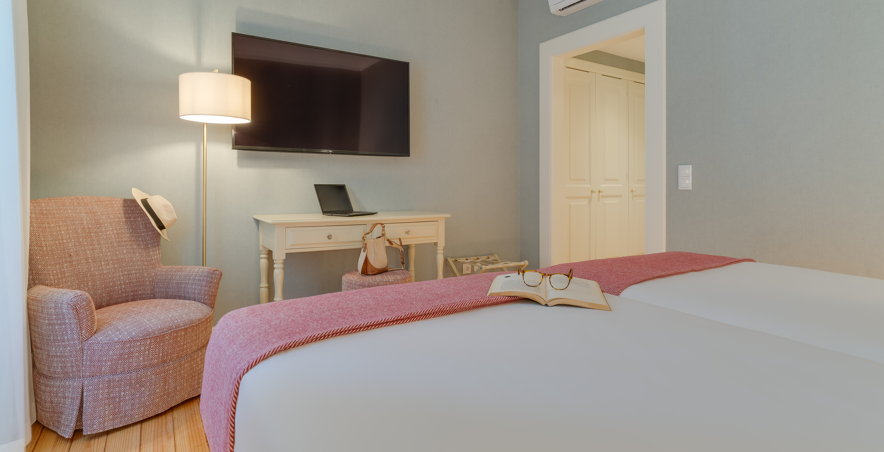 Classic Interior View room at Pestana Quinta Perestrello has a TV in front of the bed, an armchair, and a cabinet