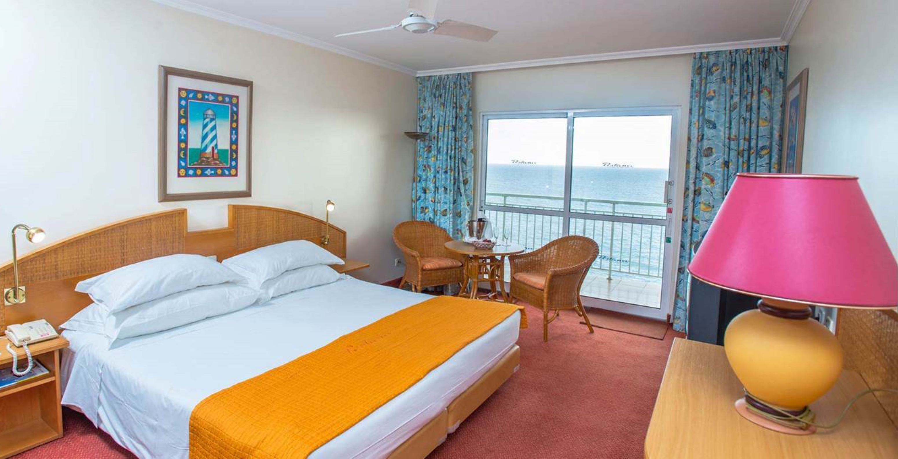 The Classic Sea View Studio at Pestana Ocean Bay All Inclusive features a double bed, a table and chairs, and a balcony