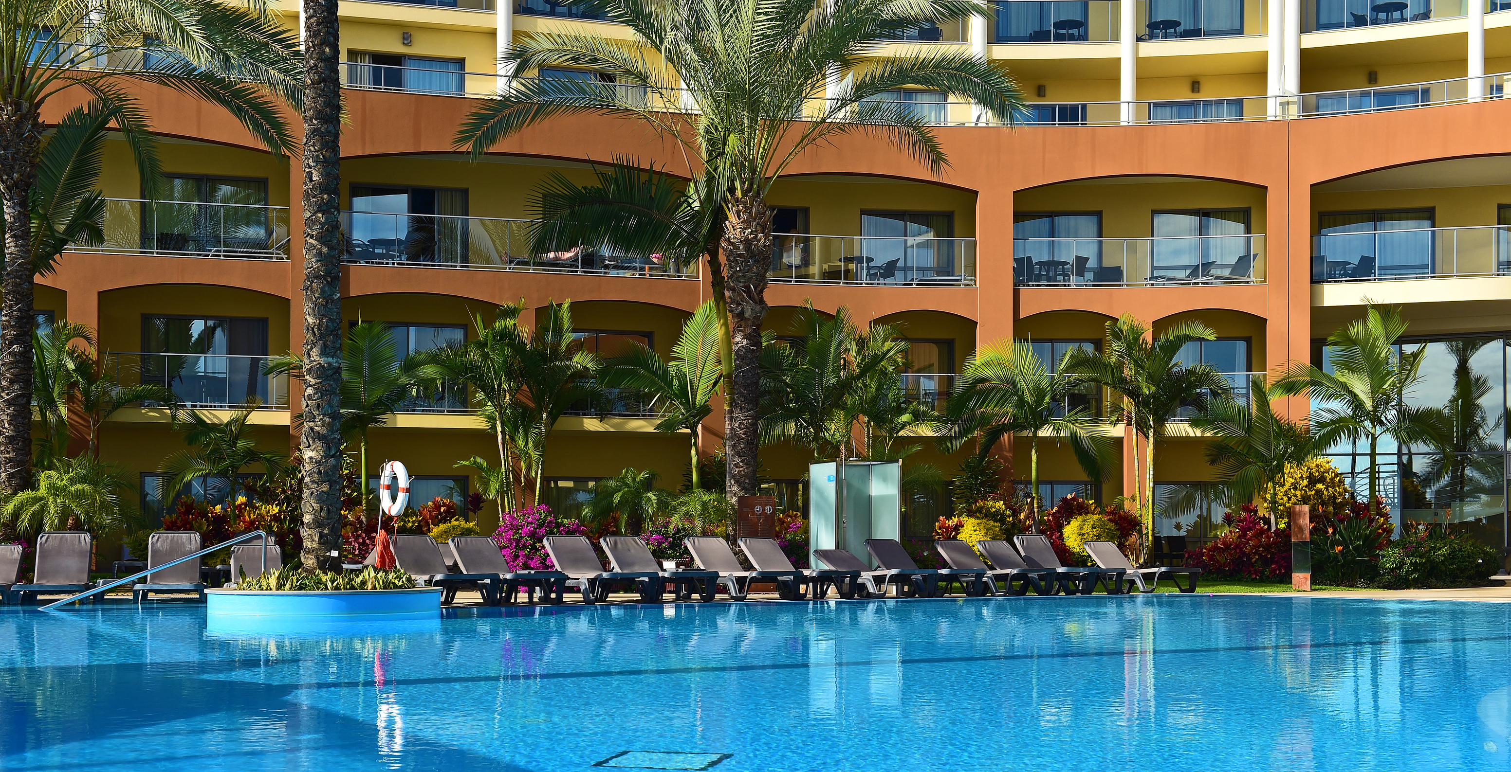 Pestana Promenade, a hotel in Madeira near the beach and Lido, has balconies overlooking the pool and loungers