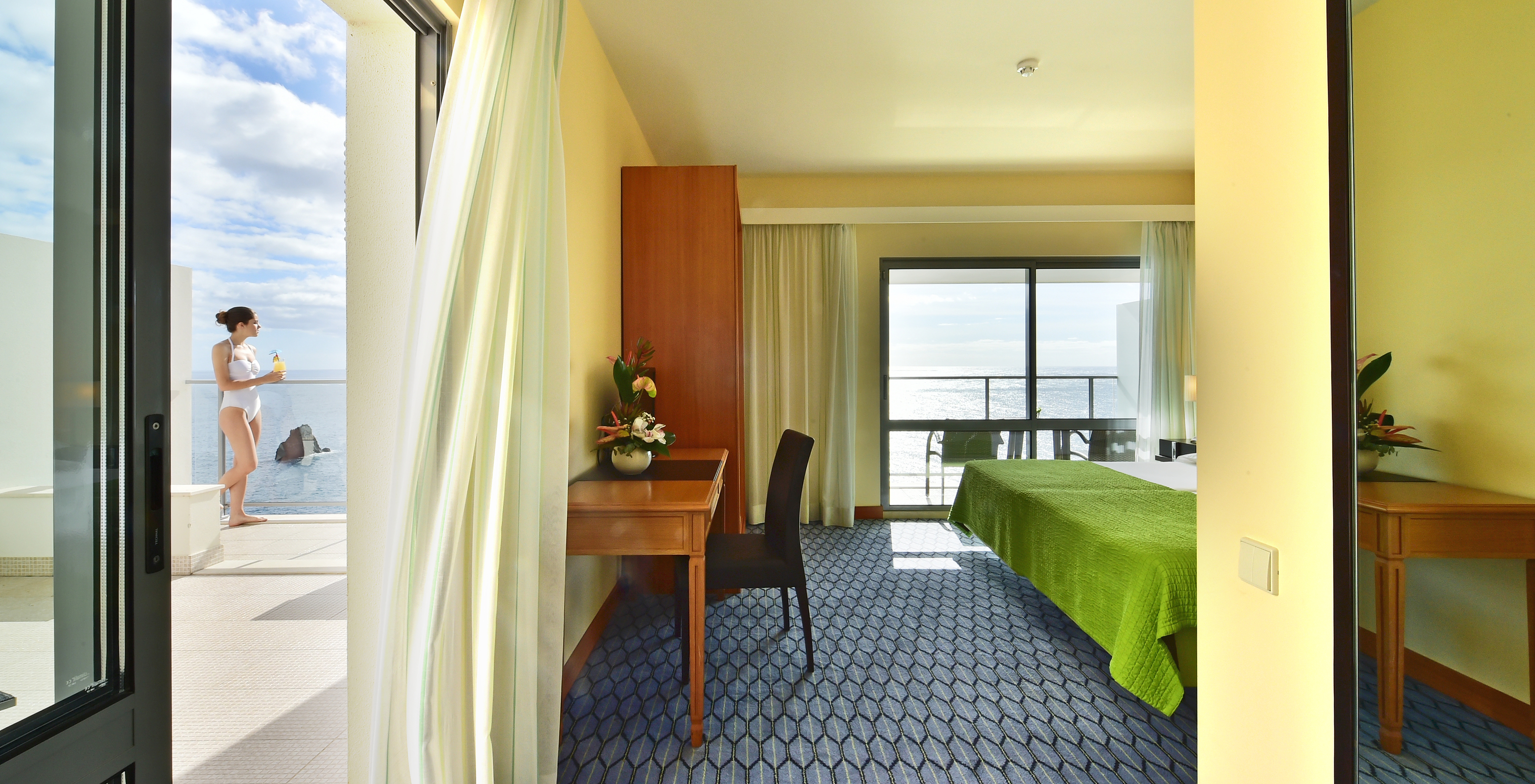 The Suite Sea View of Pestana Promenade has a desk with a chair and a spacious balcony where you can have a cocktail