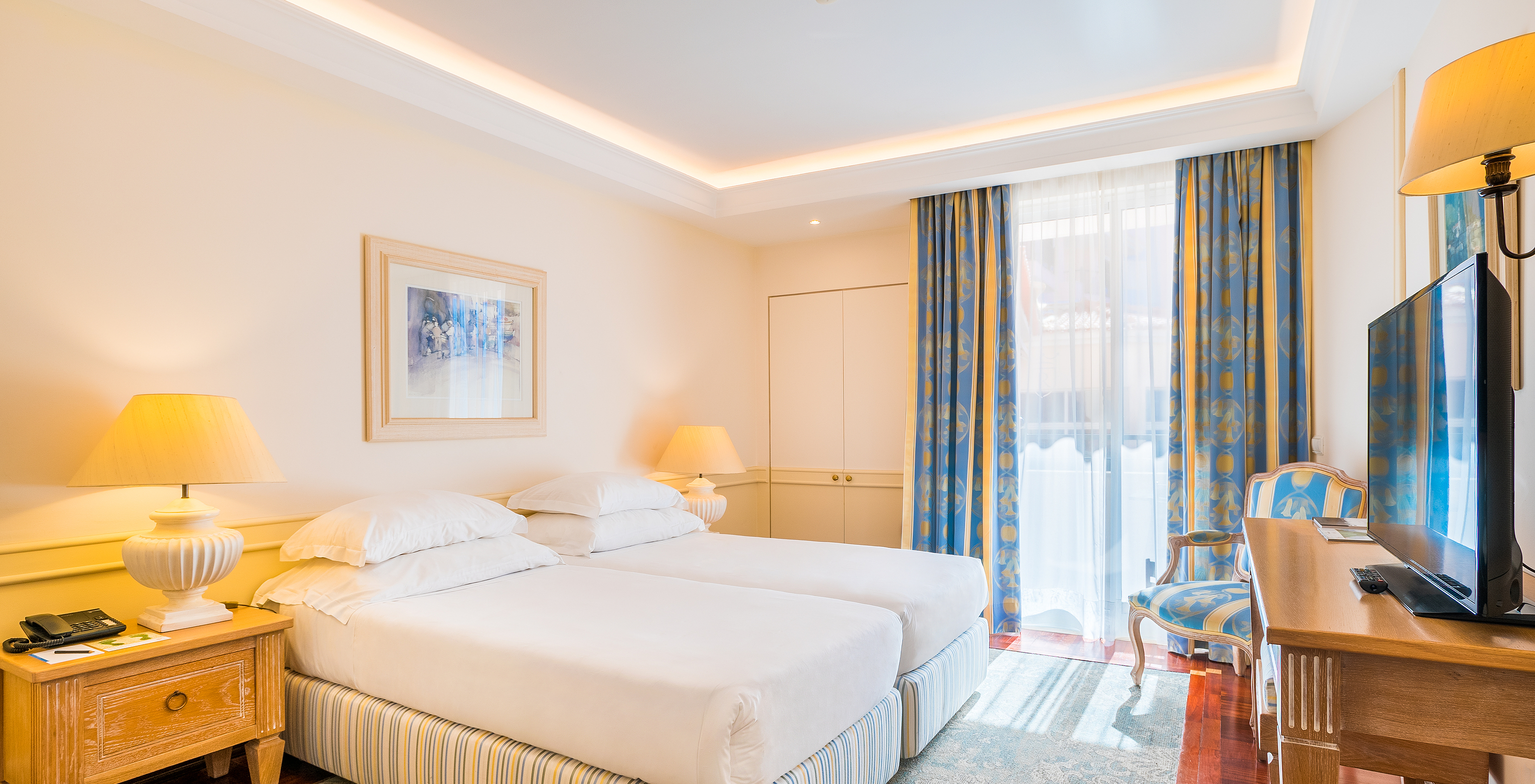 The Deluxe Room with Sea View Balcony of Pestana Royal All Inclusive has two single beds and a bedside table