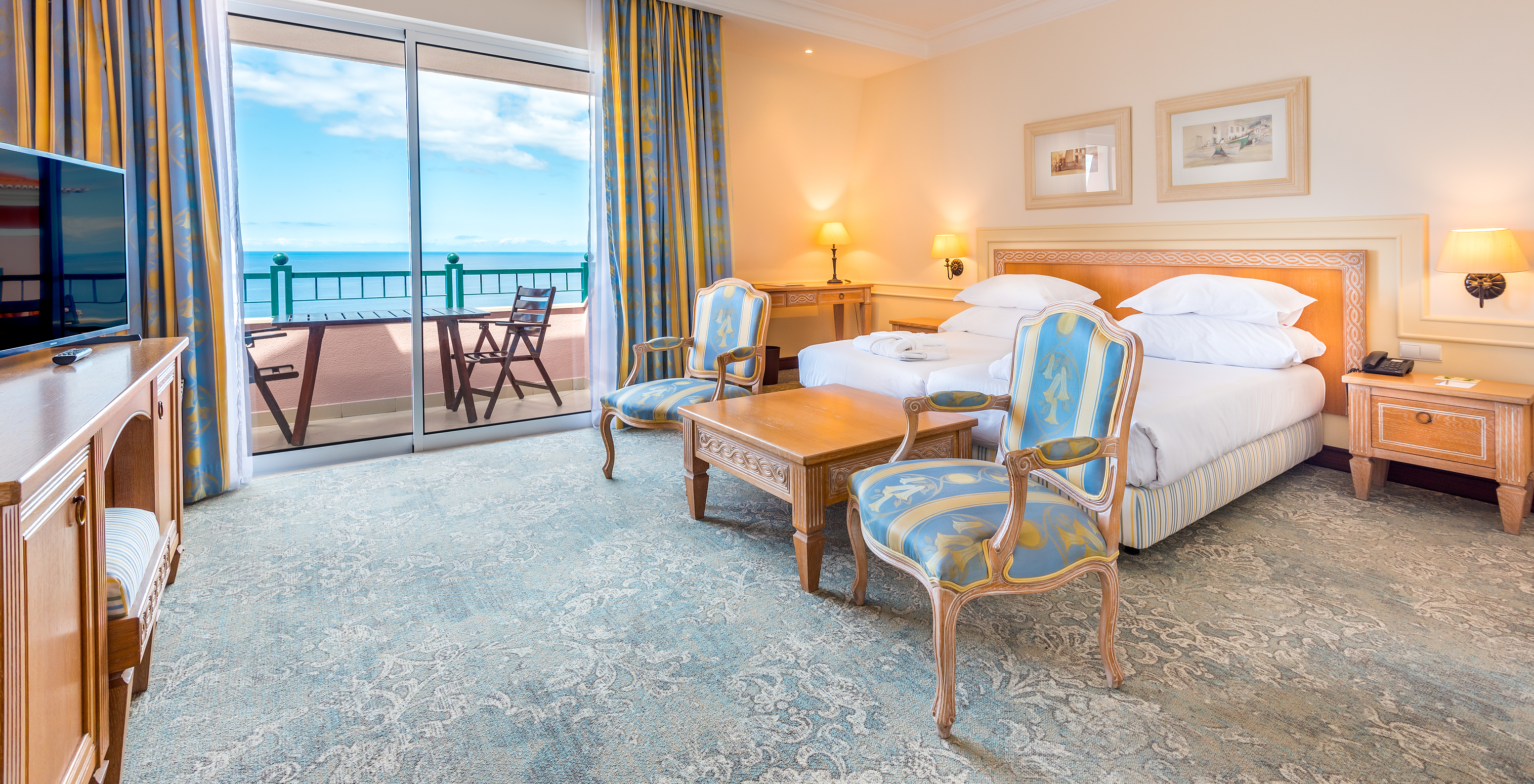 The Superior Deluxe Room with Balcony of Pestana Royal All Inclusive has a double bed, bedside table, and armchair