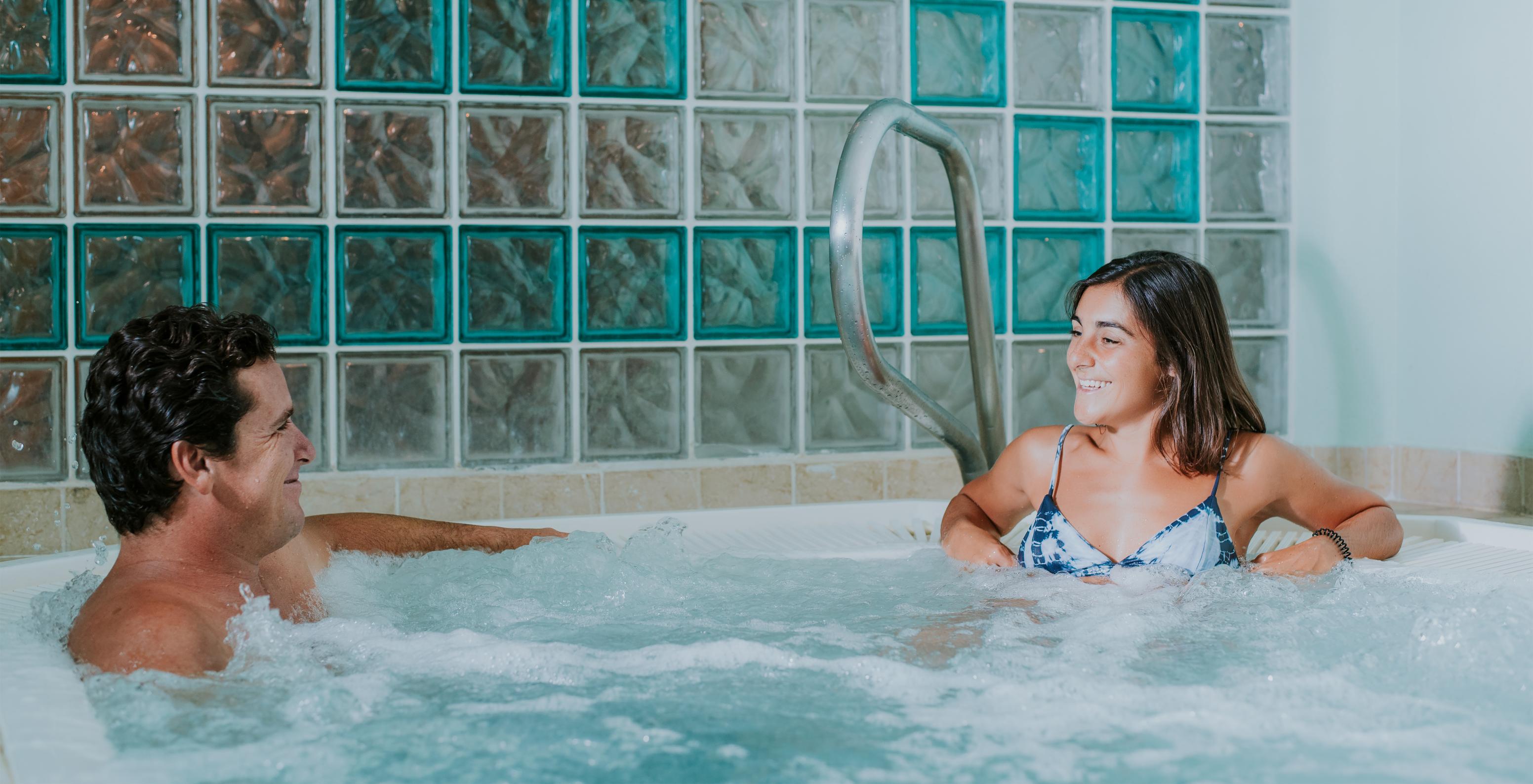 Two people socializing in the jacuzzi at Pestana Village, a Romantic Hotel in Funchal, Madeira