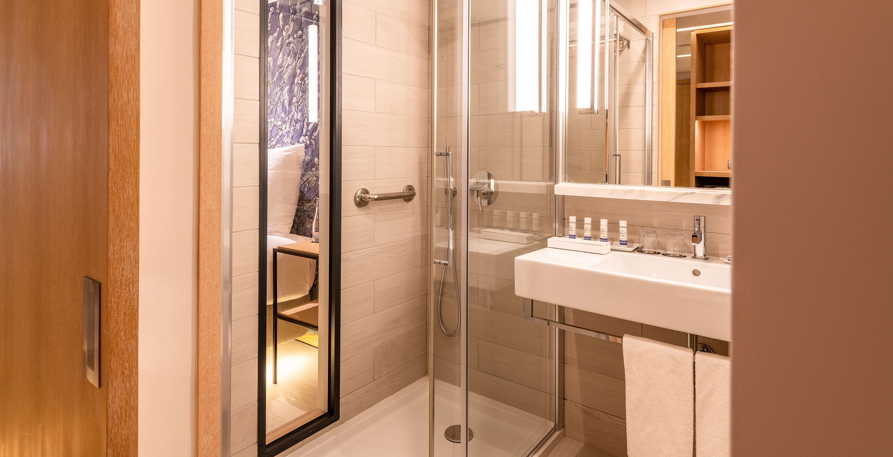 The Deluxe River View room at Pestana Douro Riverside features a bathroom with a sink, mirror, and shower