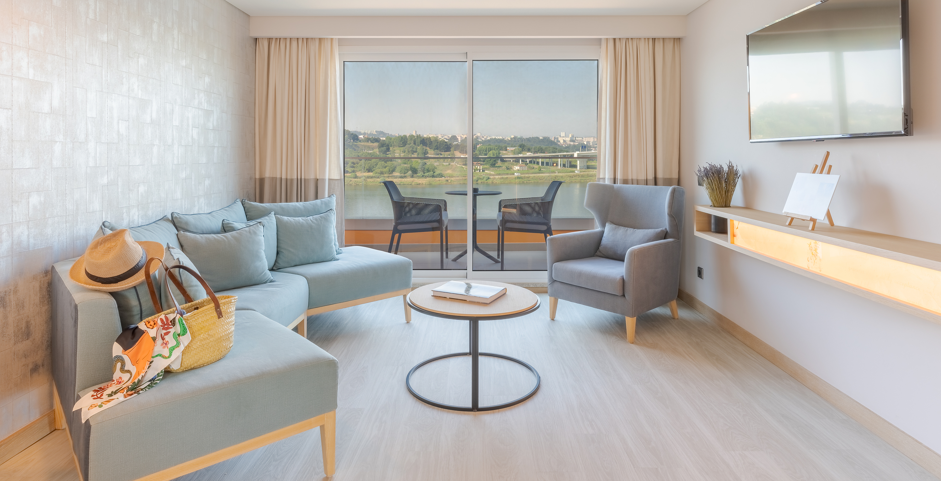 The Douro Suite at Pestana Douro Riverside features a living room with a sofa, coffee table, television, and a balcony