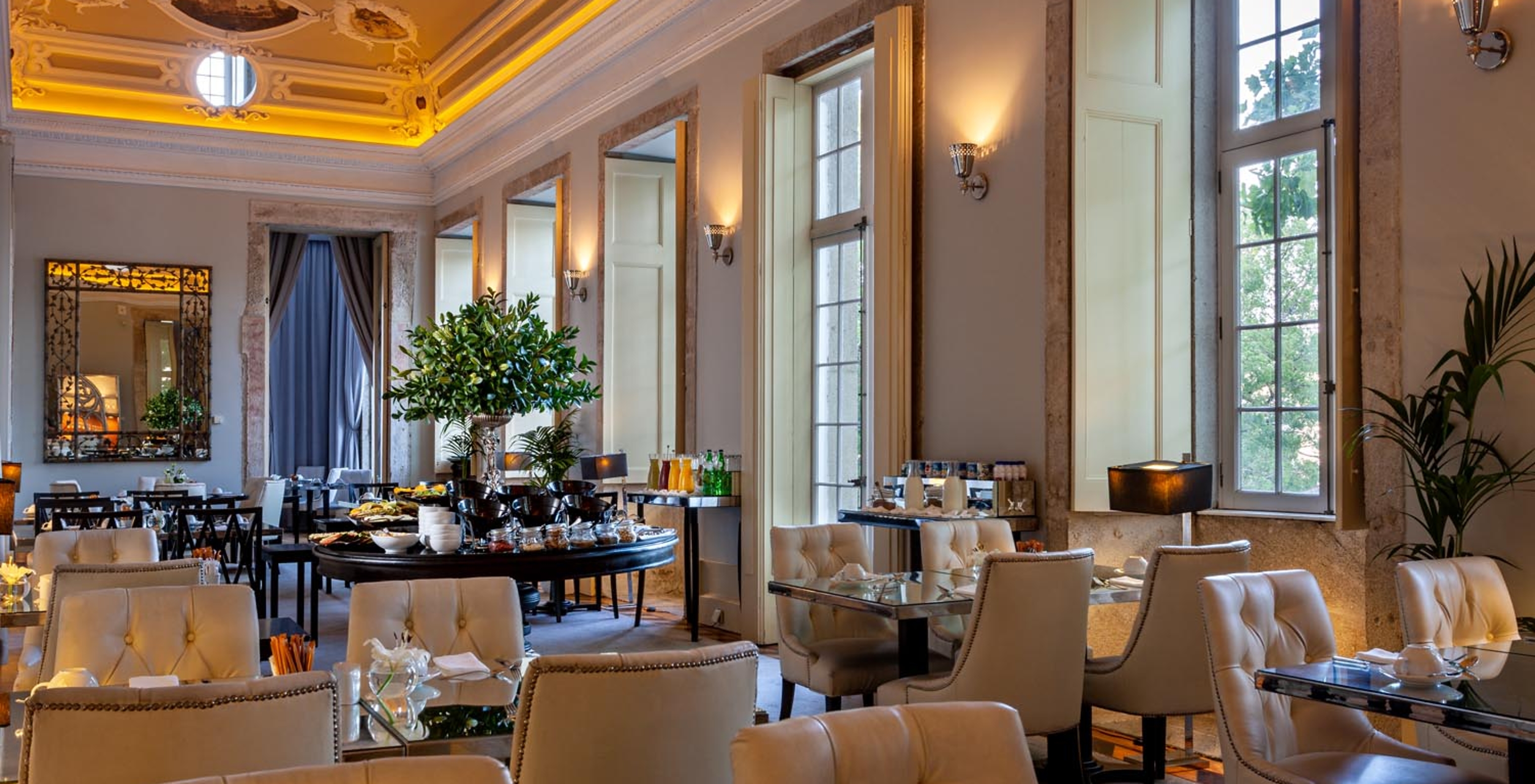 The Palatium restaurant at the 5-Star Hotel in Porto, National Monument, features luxurious decor, a mirror, and windows