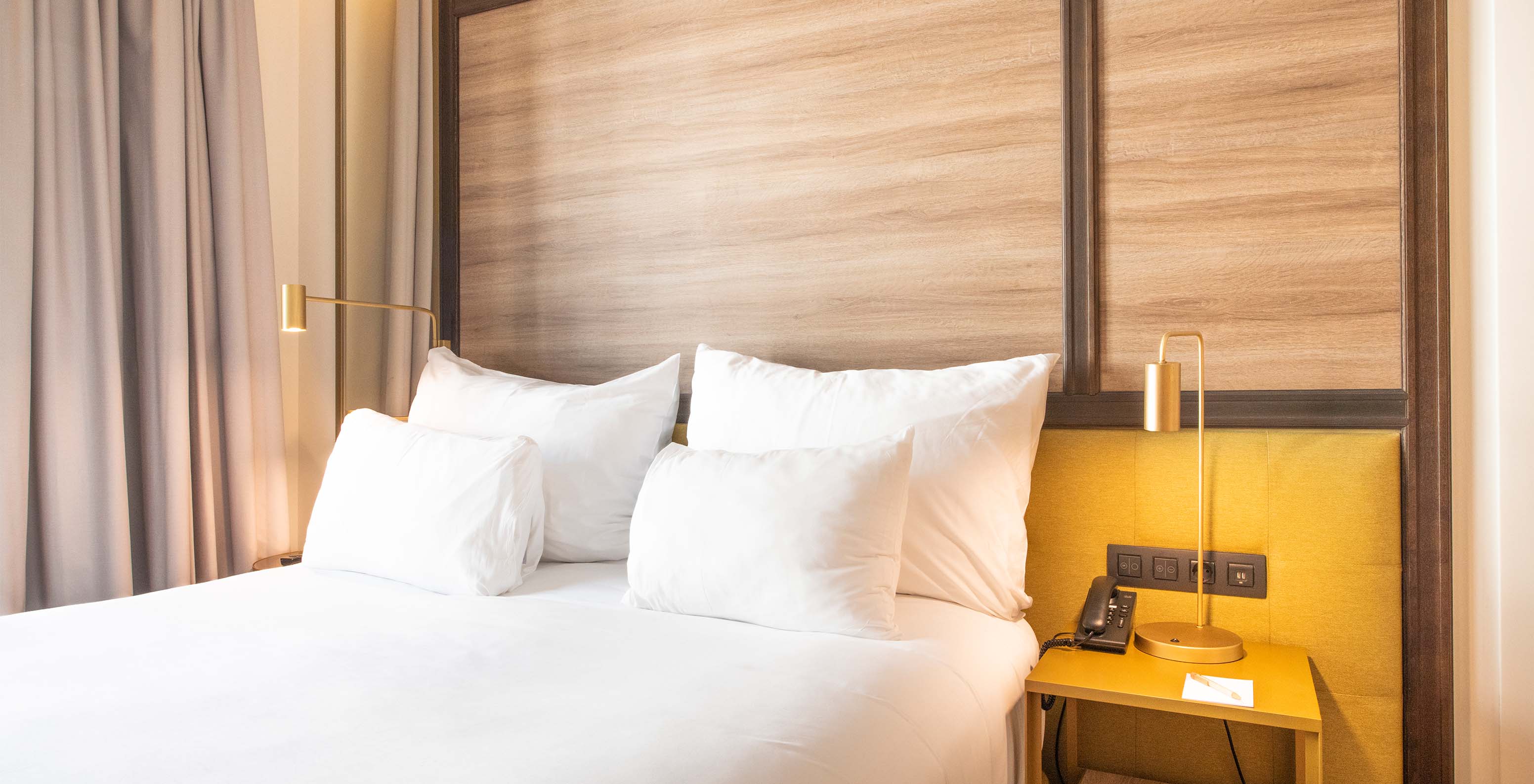 The Legend Room at Pestana CR7 Gran Vía Madrid has a double bed, bedside table, and two golden lamps