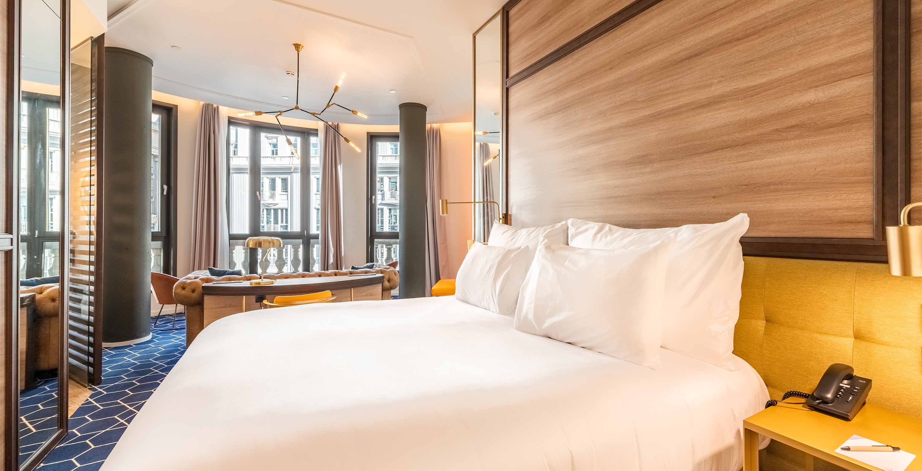 The Amazing CR7 Room at Pestana CR7 Gran Vía Madrid includes a double bed, sofa, and large panoramic windows facing Gran Vía