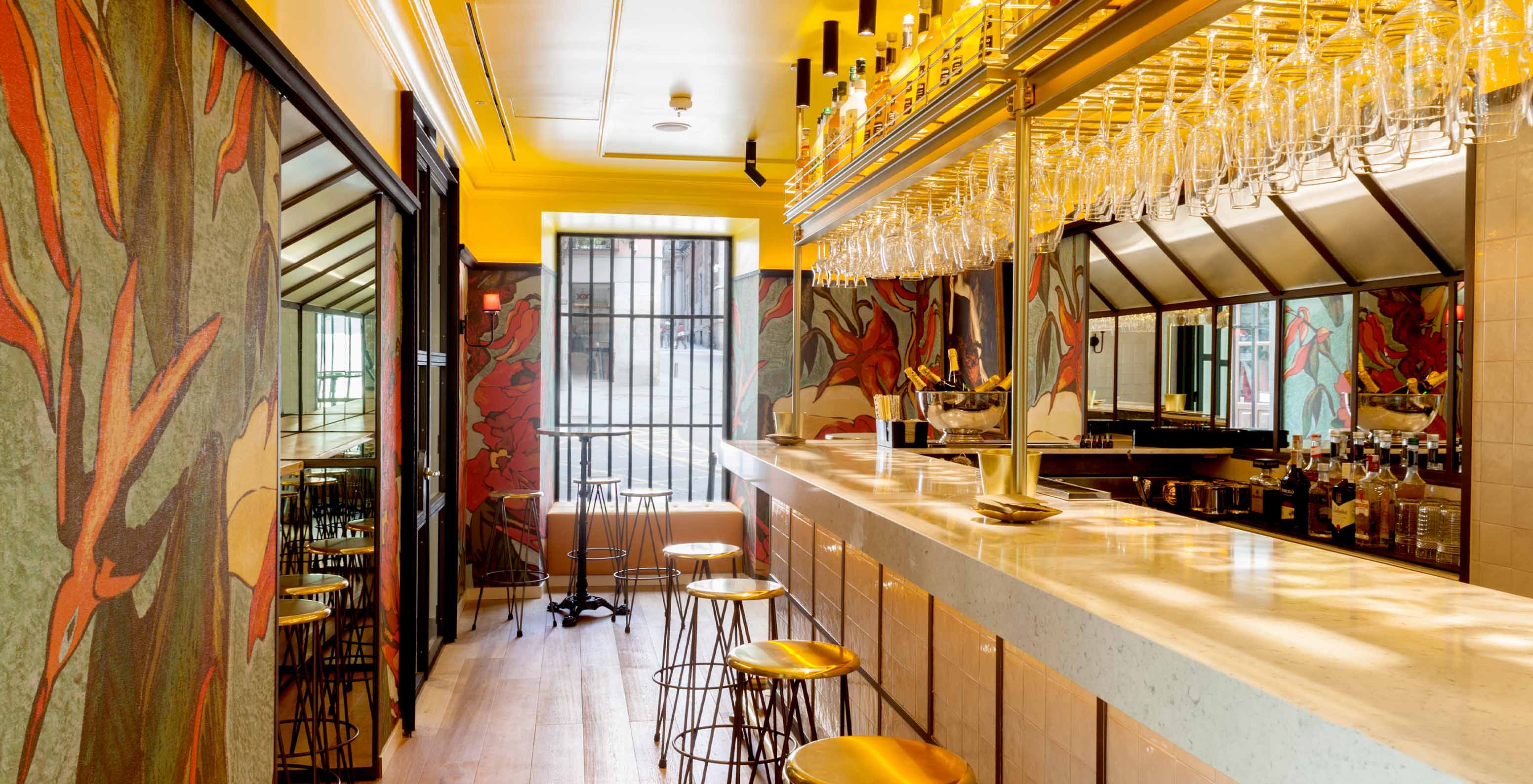 Hotel bar with pool at Plaza Mayor in Madrid, with high chairs and various alcoholic and non-alcoholic drinks