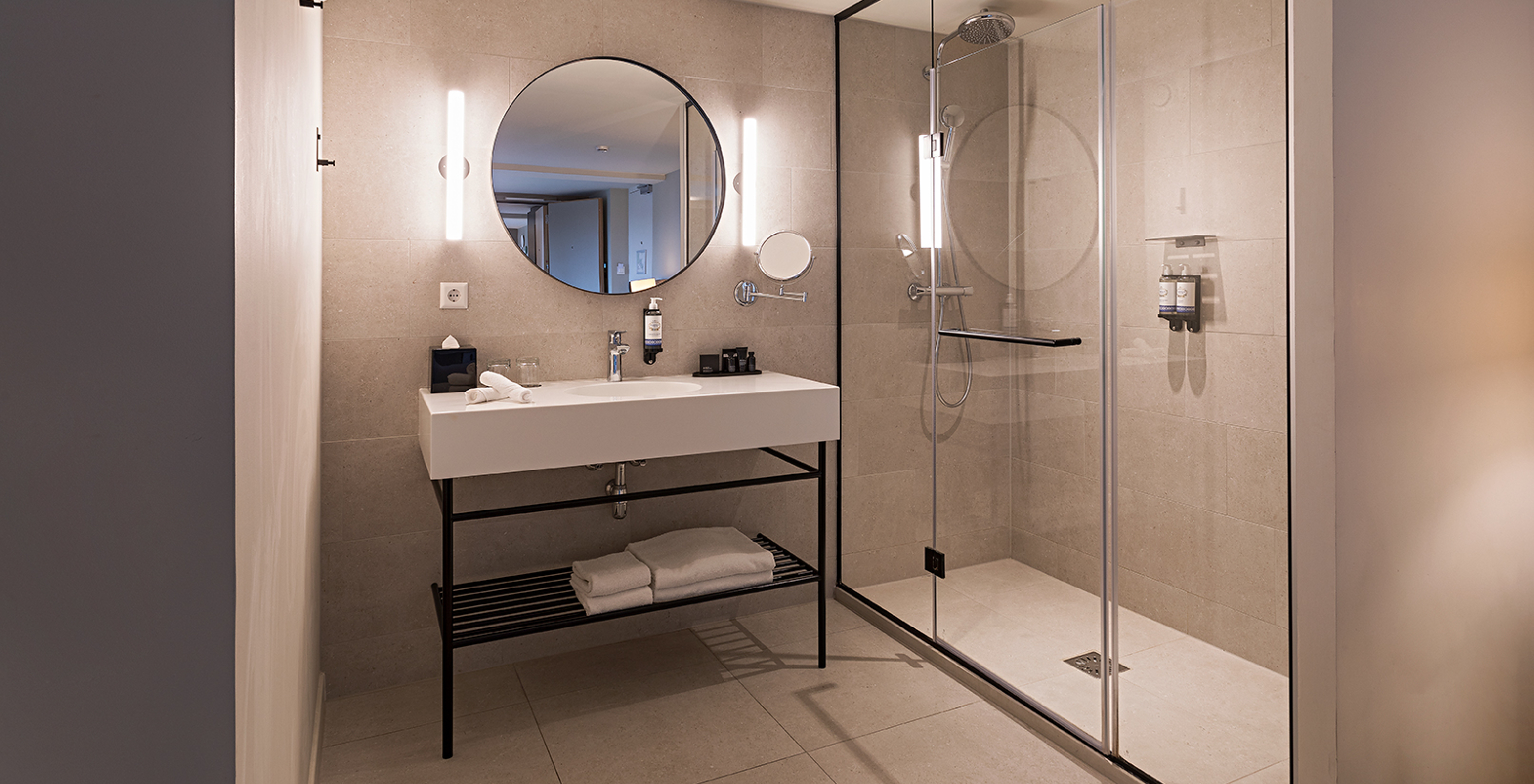 Executive Terrace room at Pestana Amsterdam Riverside has a bathroom with mirror, sink, towels and shower