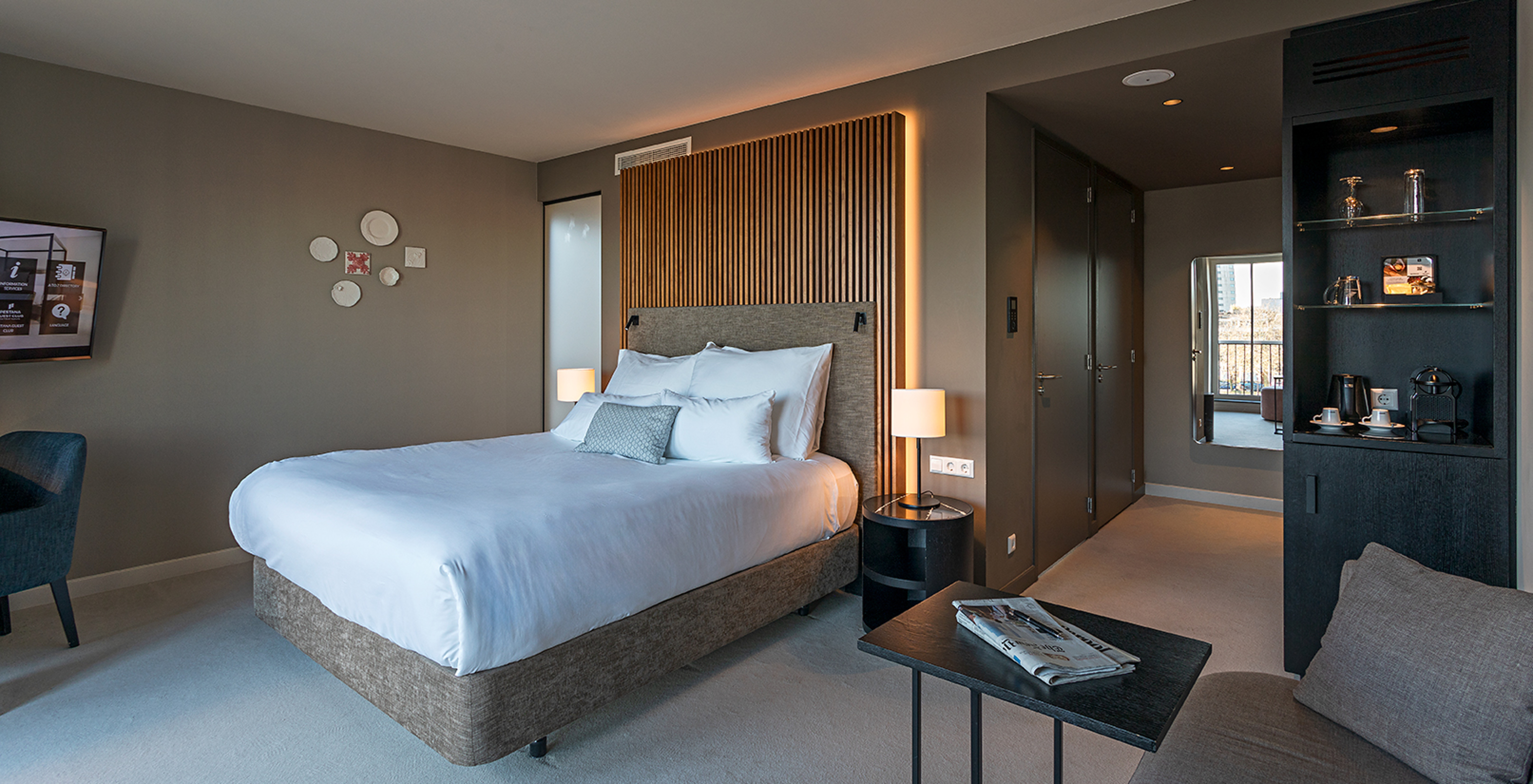 Premium - River View room at Pestana Amsterdam Riverside has a double bed, with bedside table and lamp