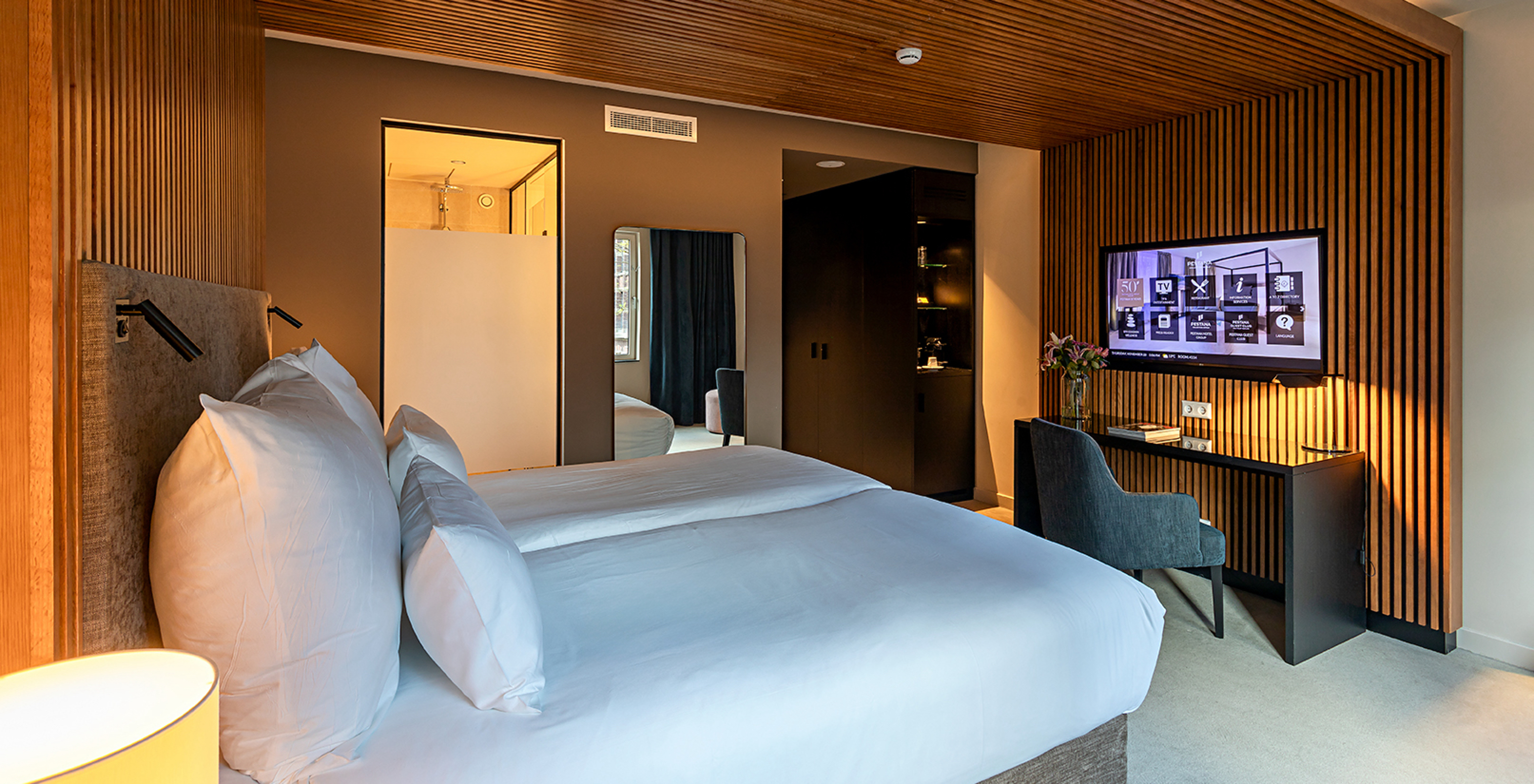 Executive room at Pestana Amsterdam Riverside has two single beds, TV in front of the bed, and a desk