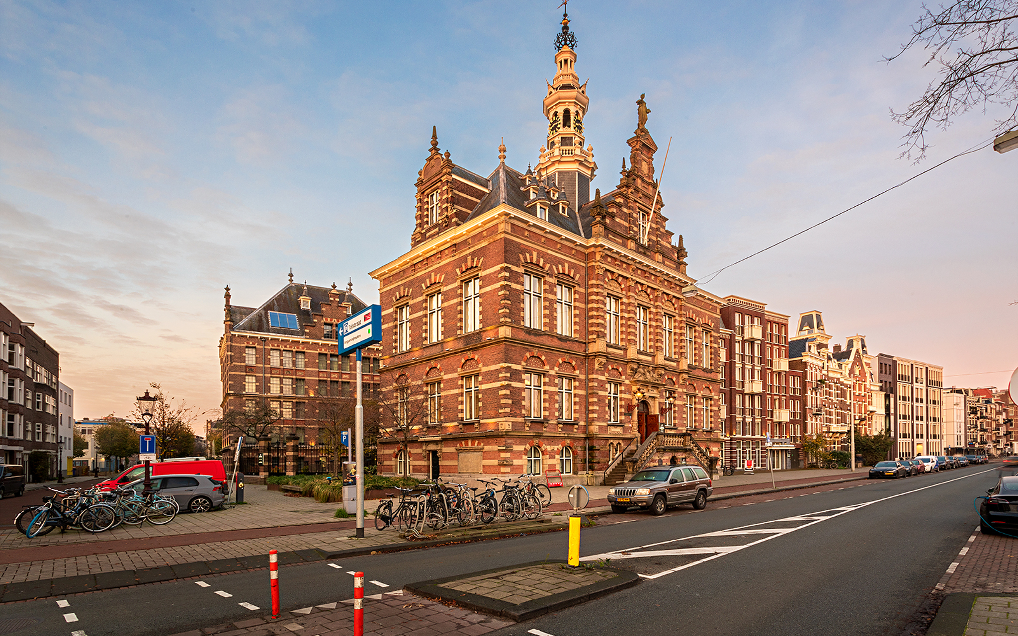 Exterior view of Pestana Amsterdam Riverside Exterior view of Pestana Amsterdam Riverside, with red bricks, parked bicycles, and a clear sky
