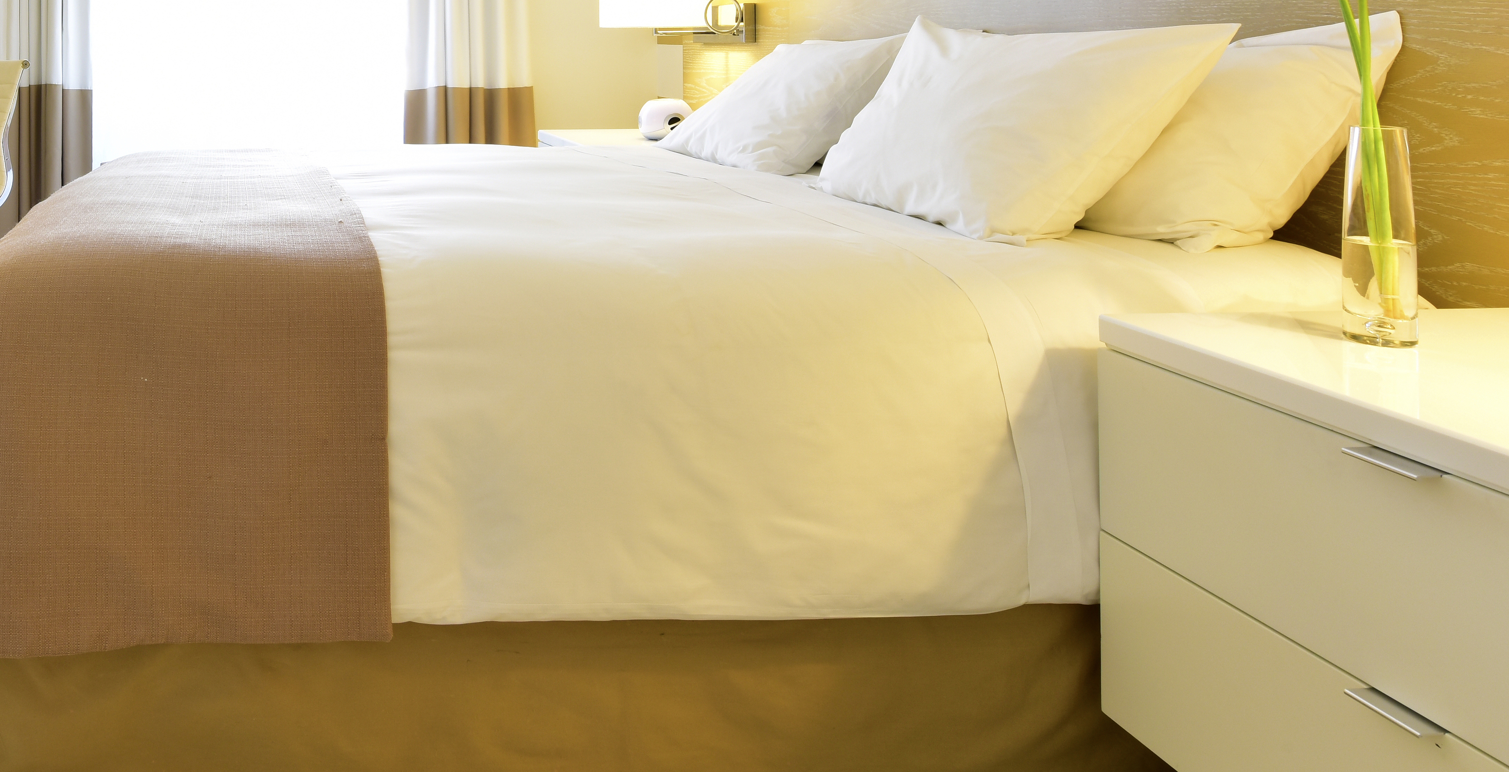 The South Beach King - ADA Room at Pestana Miami South Beach has a double bed and bedside table