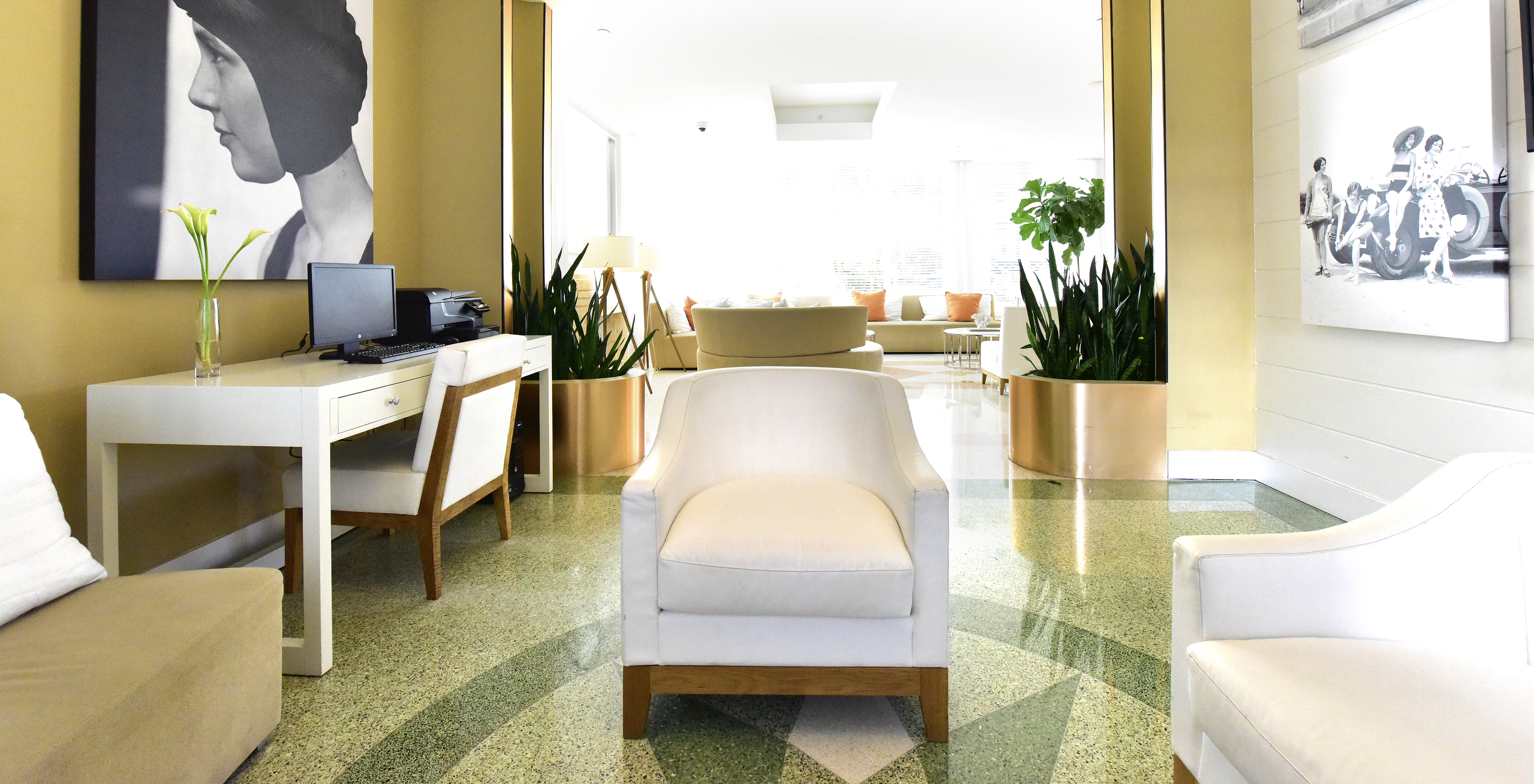 Workspace in the hotel lobby equipped with a computer, photocopier, desk, and chairs