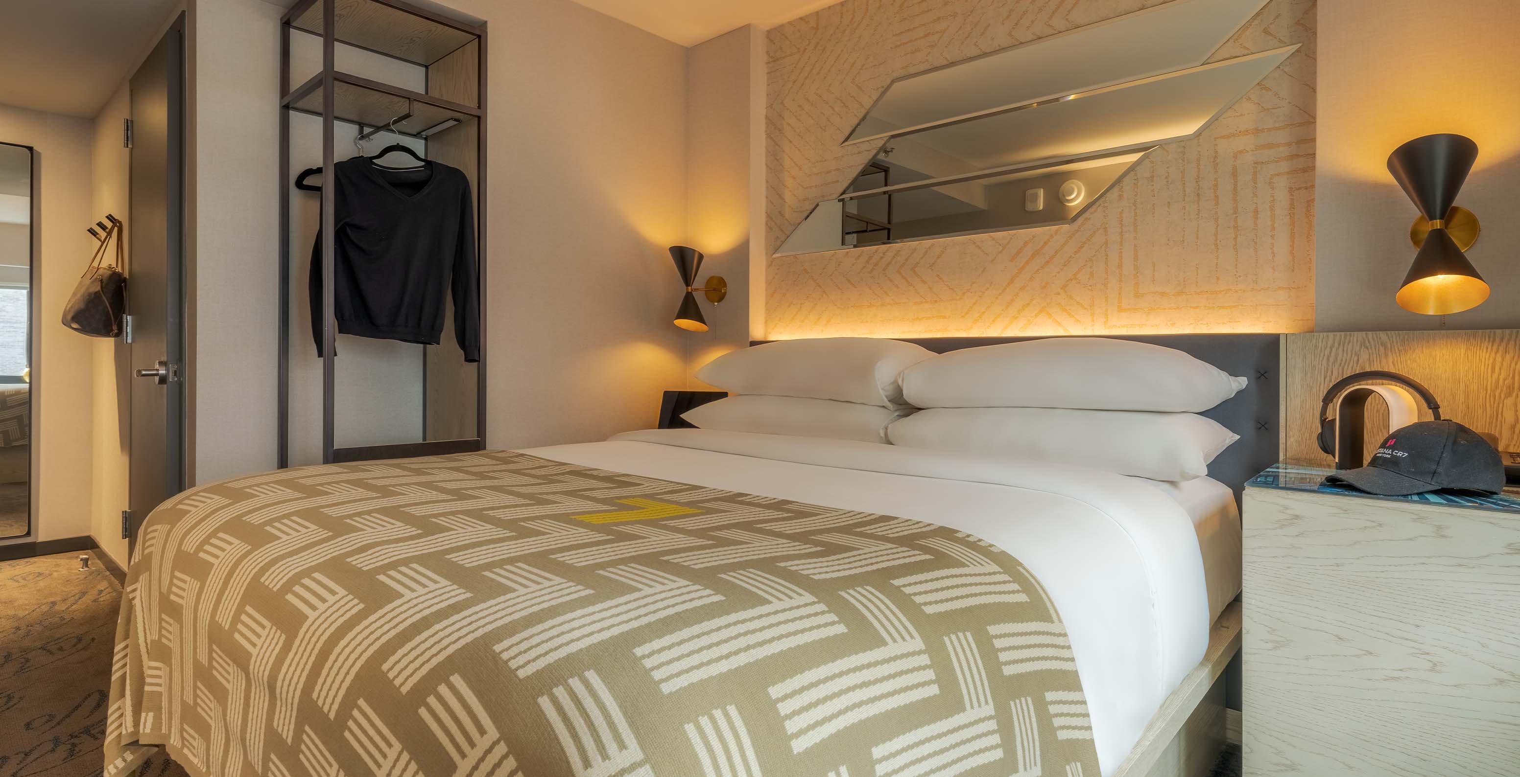 The Comfort Street View at Pestana CR7 Times Square has a double bed with a bedspread with the number seven and a wardrobe