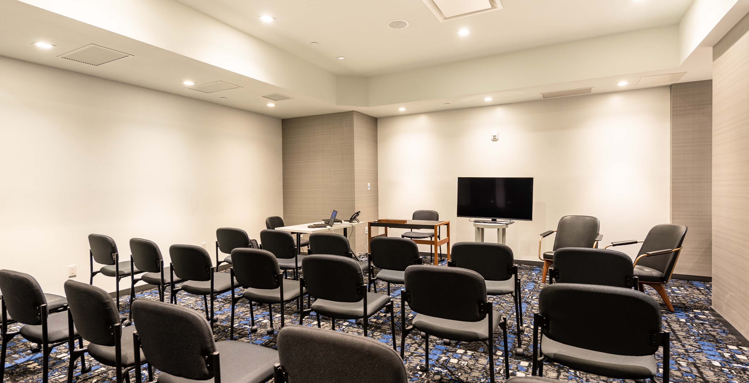 Pestana CR7 Times Square, a hotel in Manhattan, has a meeting room with chairs and a television