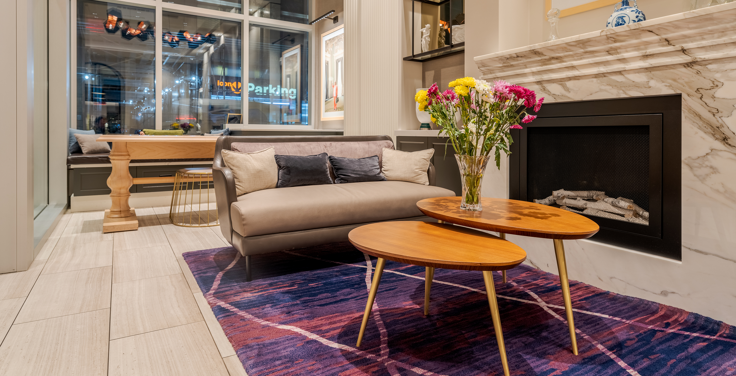 Lobby of Pestana Park Avenue, with sofa, marble fireplace, coffee table and a city view through large windows