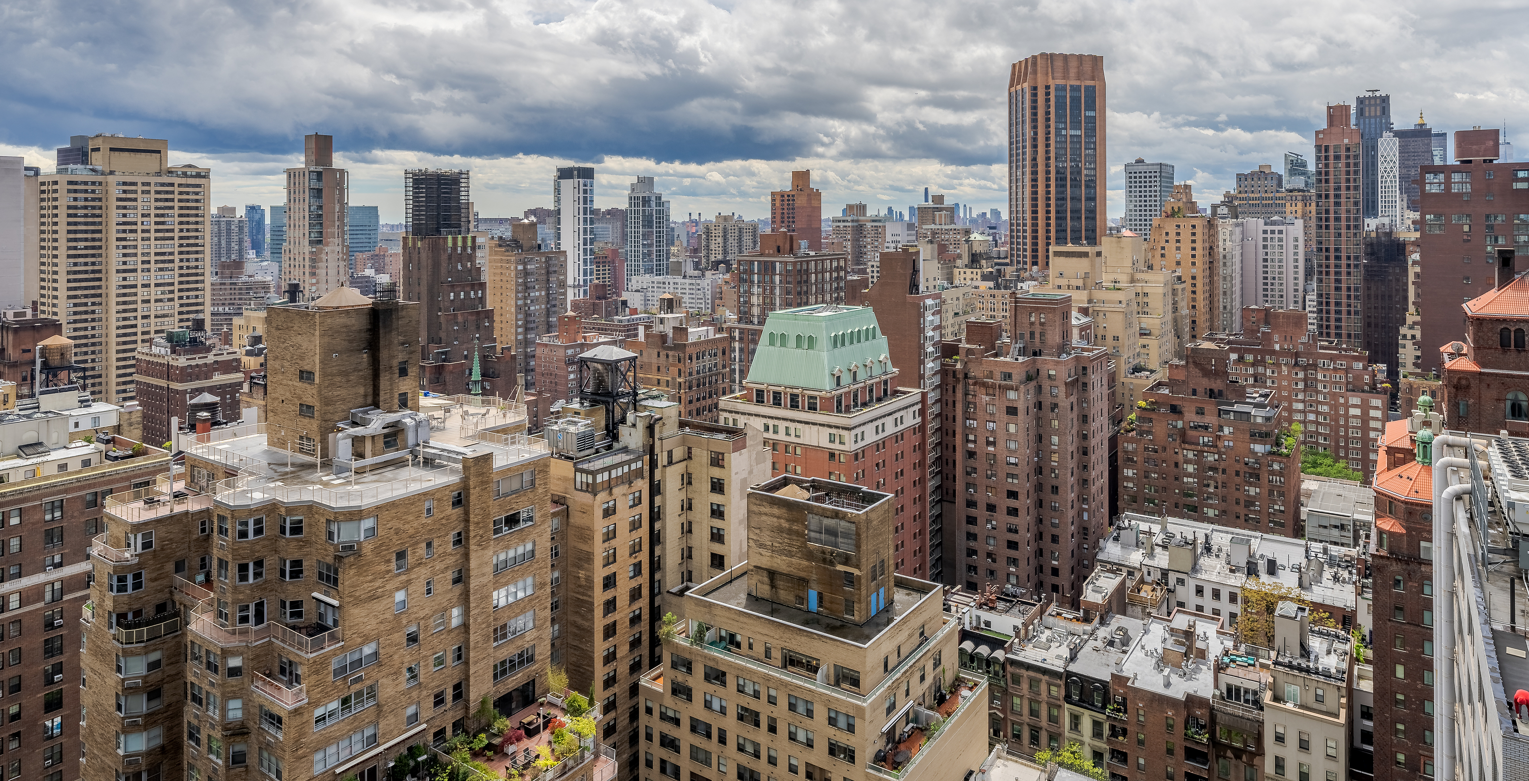 Panoramic view of Manhattan skyline with buildings of varying heights and architectural styles