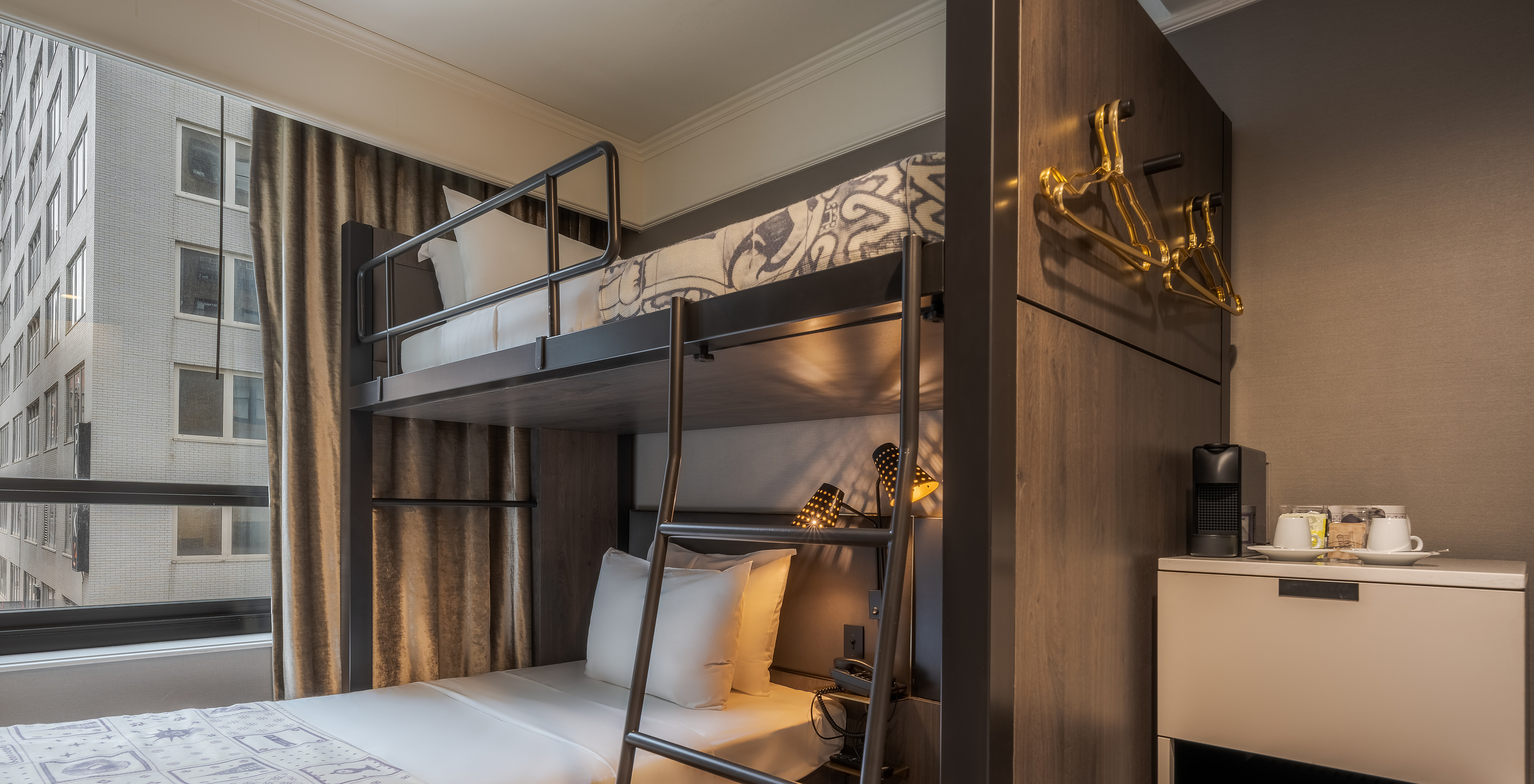 The Cabin room - ADA at Pestana Park Avenue has a bunk bed with two single beds, a fridge and a coffee machine