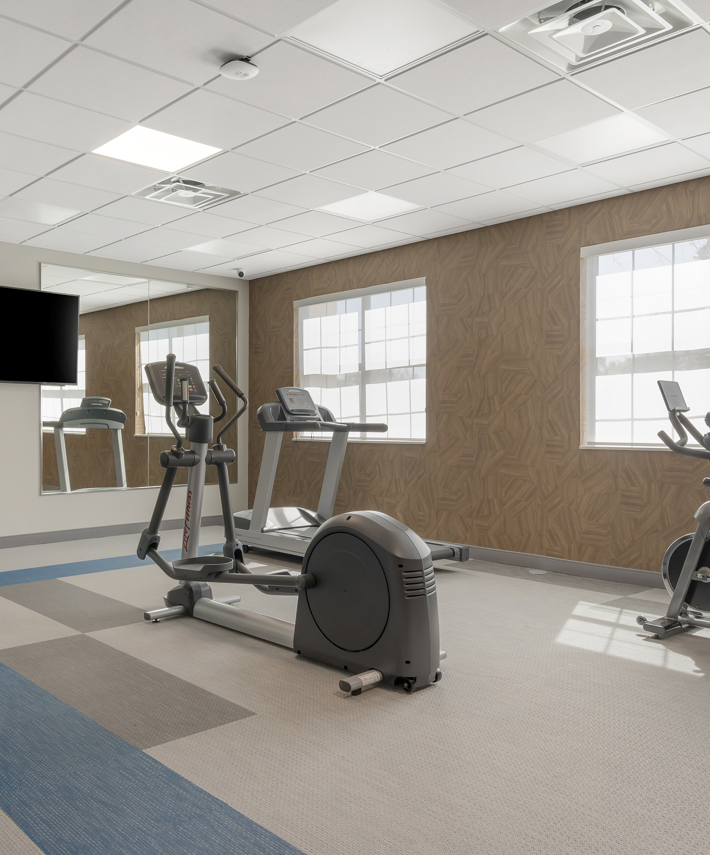 Pestana Orlando hotel with pool near Disney features a gym with machines and a television