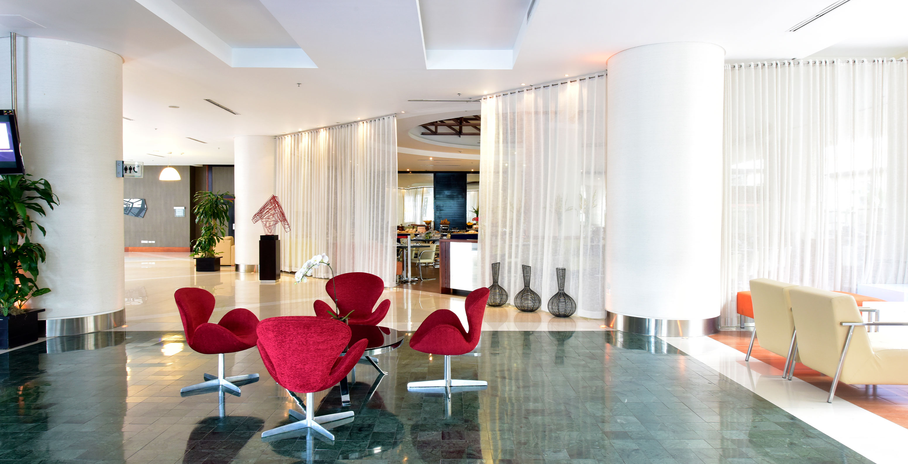 The Lobby Bar in Caracas has a relaxed vibe with red armchairs for enjoying drinks