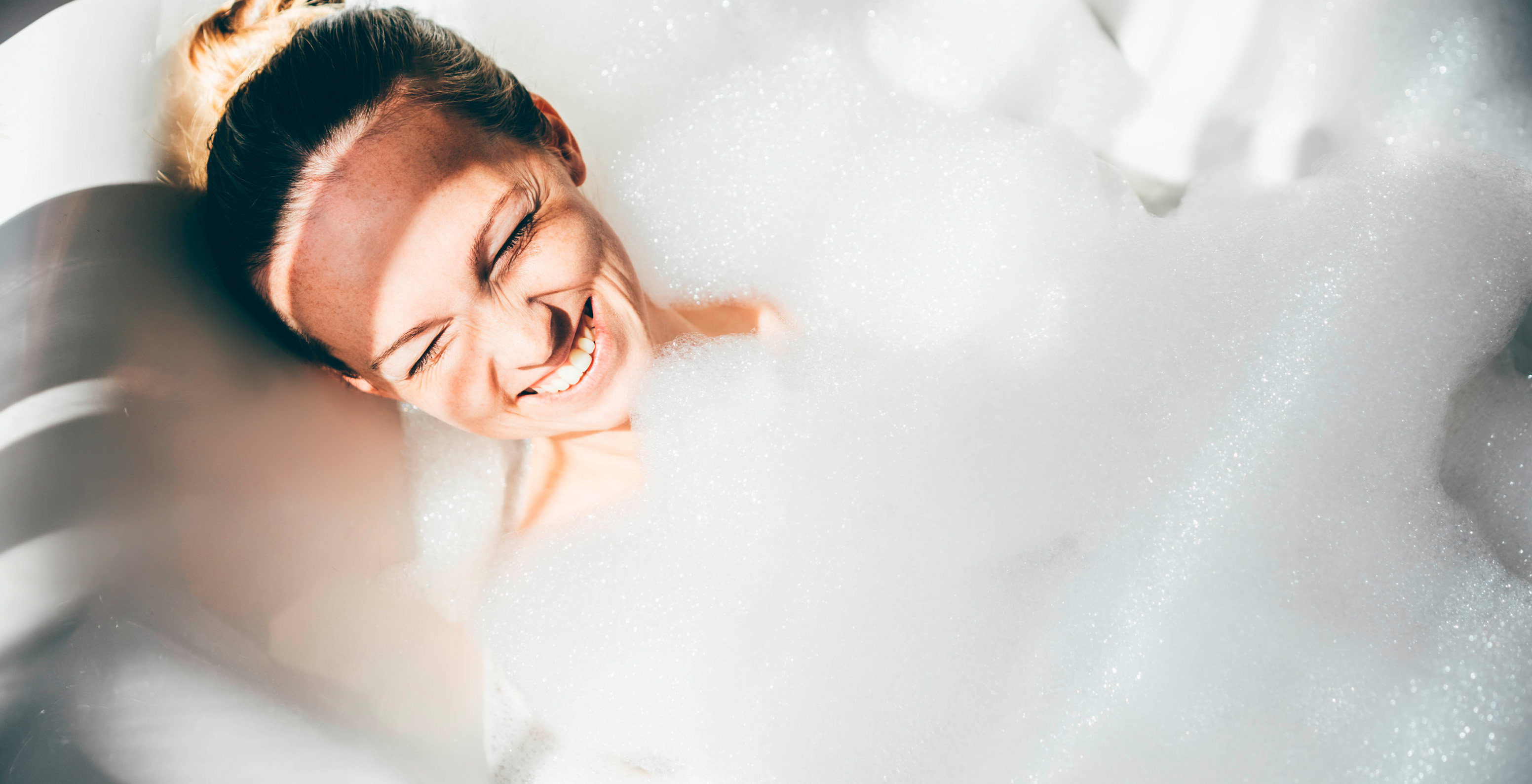 Chica sonriente relajándose en el jacuzzi del hotel en Caracas, cerca del área financiera